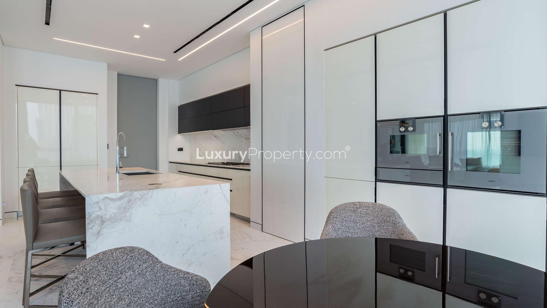 "Modern gym in Palme Couture Apartment, Palm Jumeirah with sea view, fully equipped facilities.",Modern kitchen in fully upgraded Palme Couture apartment, Palm Jumeirah, featuring sleek design elements