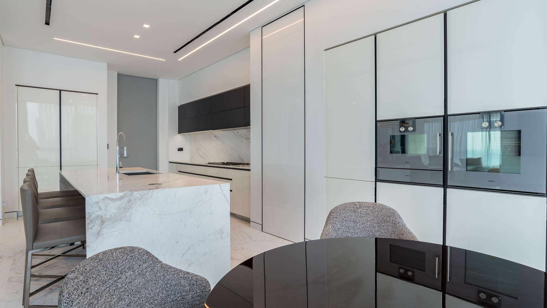 "Modern gym in Palme Couture Apartment, Palm Jumeirah with sea view, fully equipped facilities.",Modern kitchen in fully upgraded Palme Couture apartment, Palm Jumeirah, featuring sleek design elements