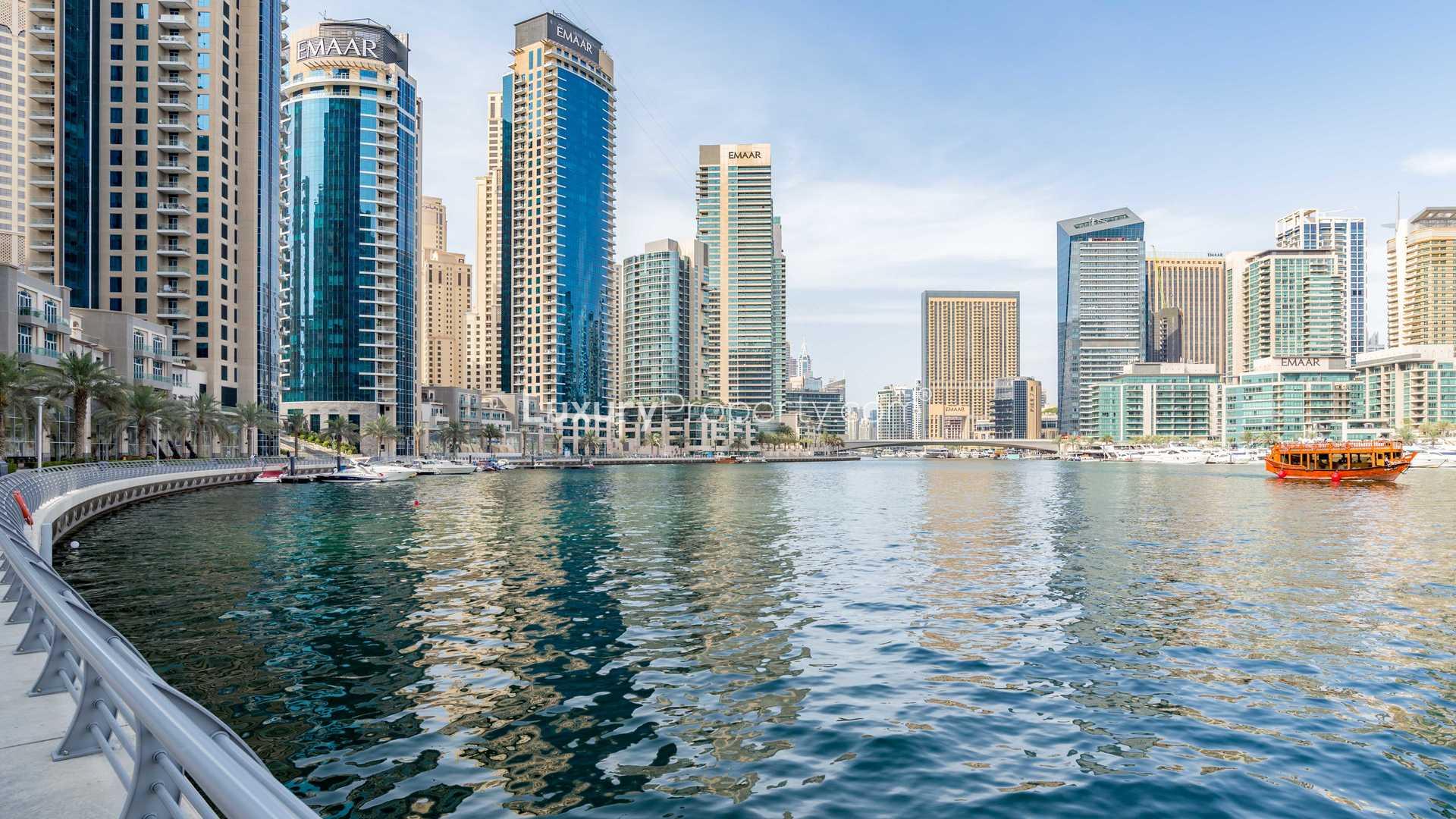 Dubai Marina waterfront view with yachts and modern skyscrapers near Paloma Tower apartment
