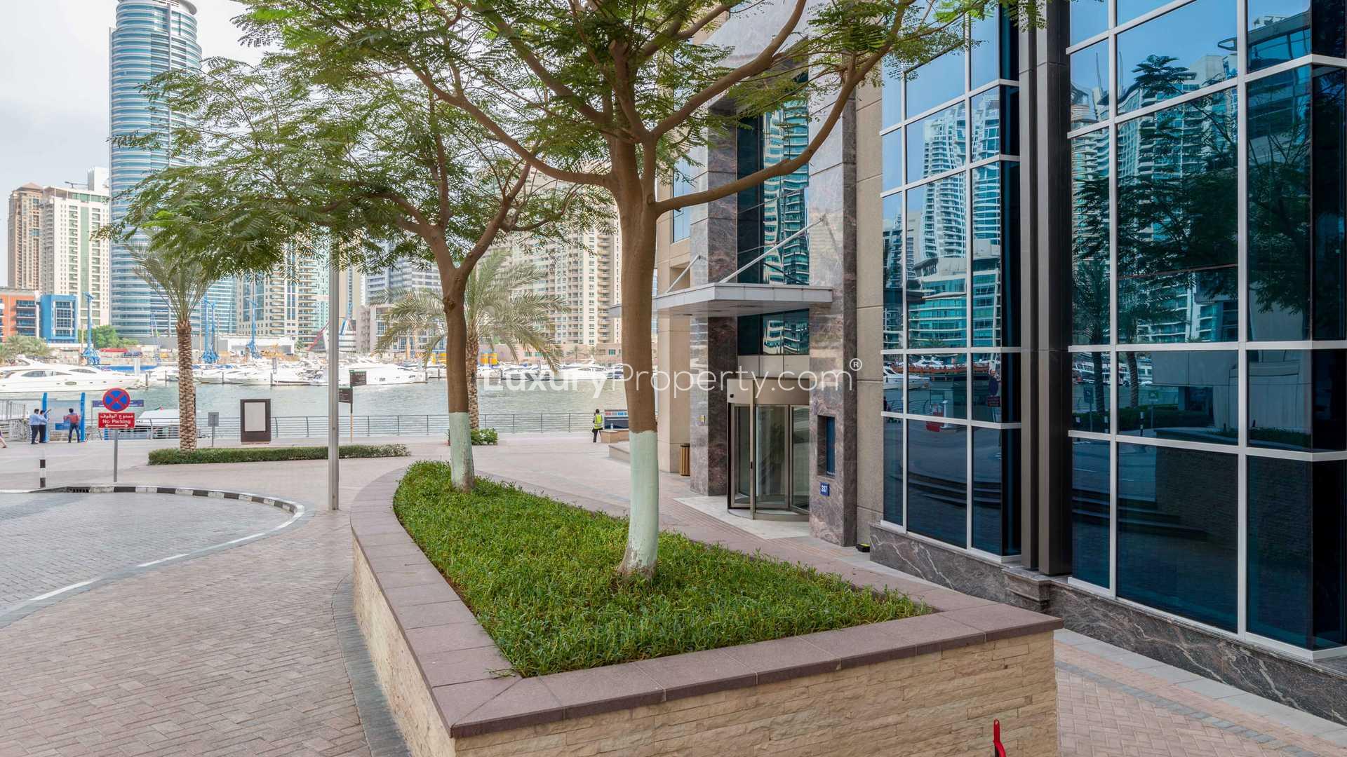 Dining area with wooden table in Paloma Tower apartment, Dubai Marina