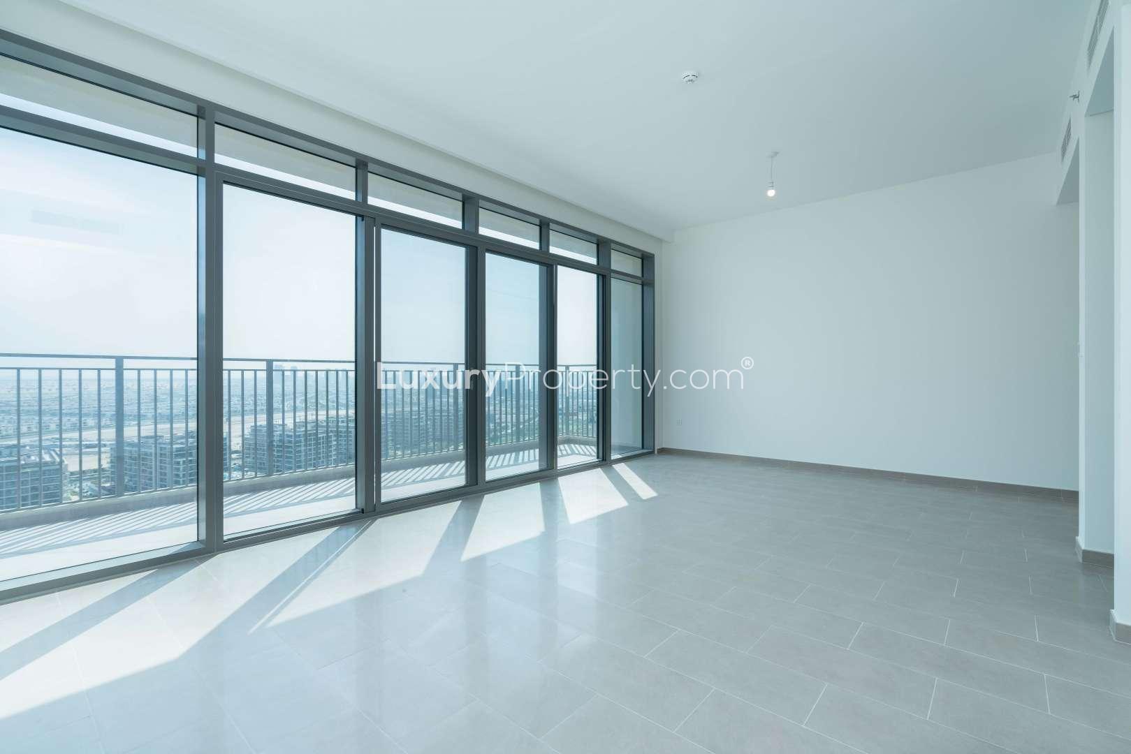 Bright living room with floor-to-ceiling windows in Dubai Hills Estate apartment for sale