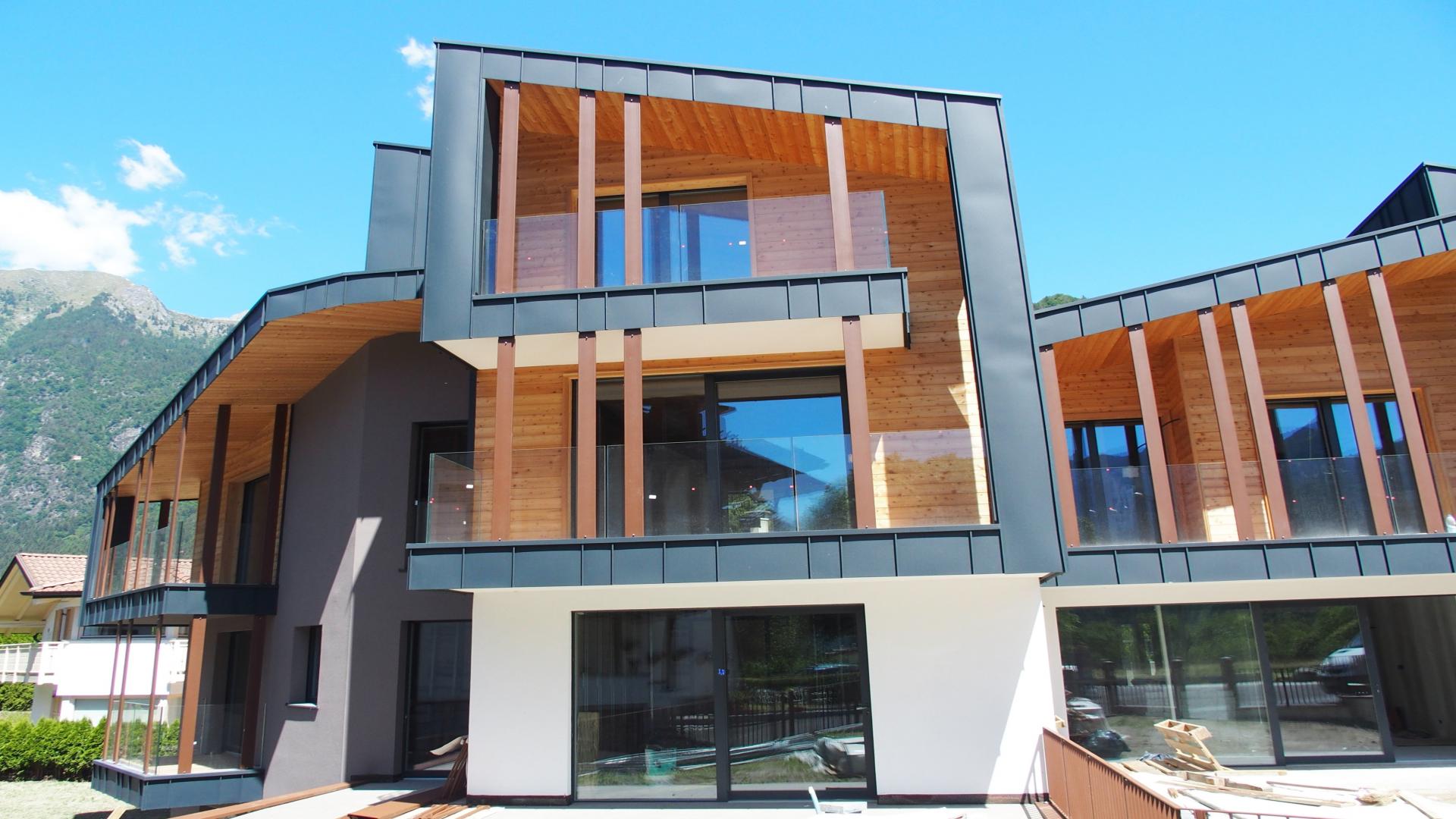 Three-bedroom chalet for sale in Pinzolo, Italy, featuring modern wood and glass architecture