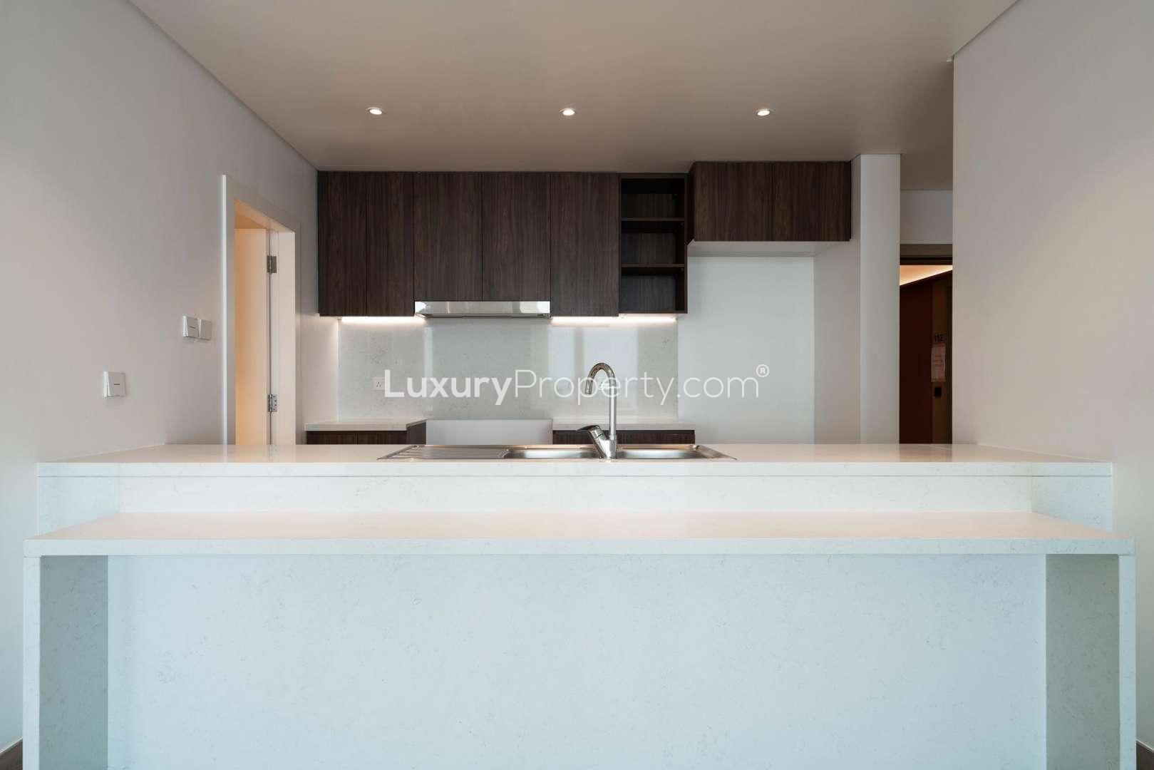 La Mer entrance with palm trees, Jumeirah community, near three-bed apartment for sale