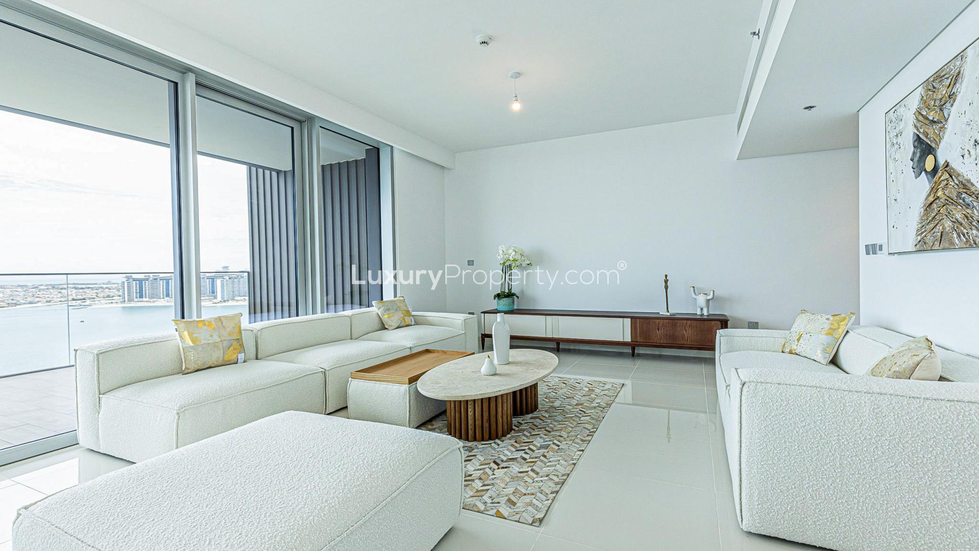 Luxurious living room with modern furniture and sea views at Emaar Beachfront apartment
