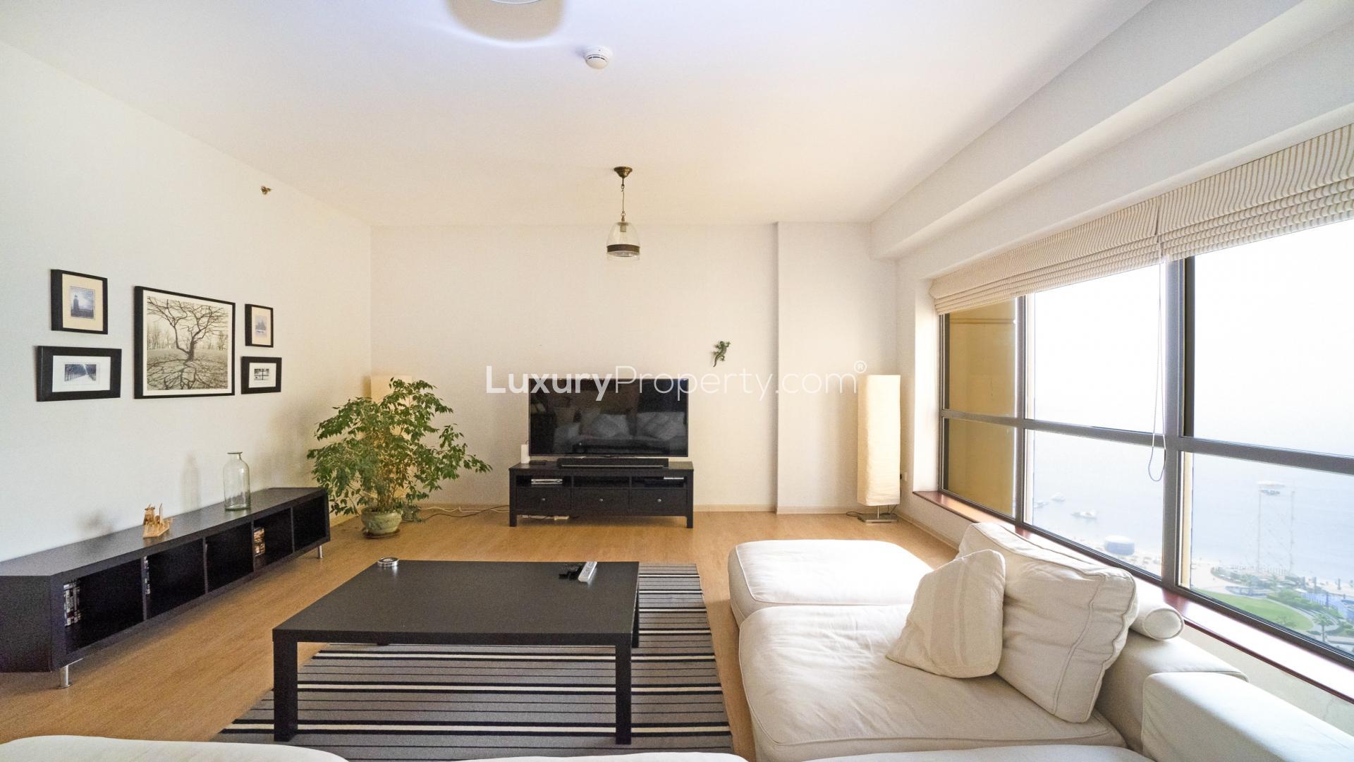 Spacious living room in 3-bedroom JBR apartment, modern decor, bright and airy space