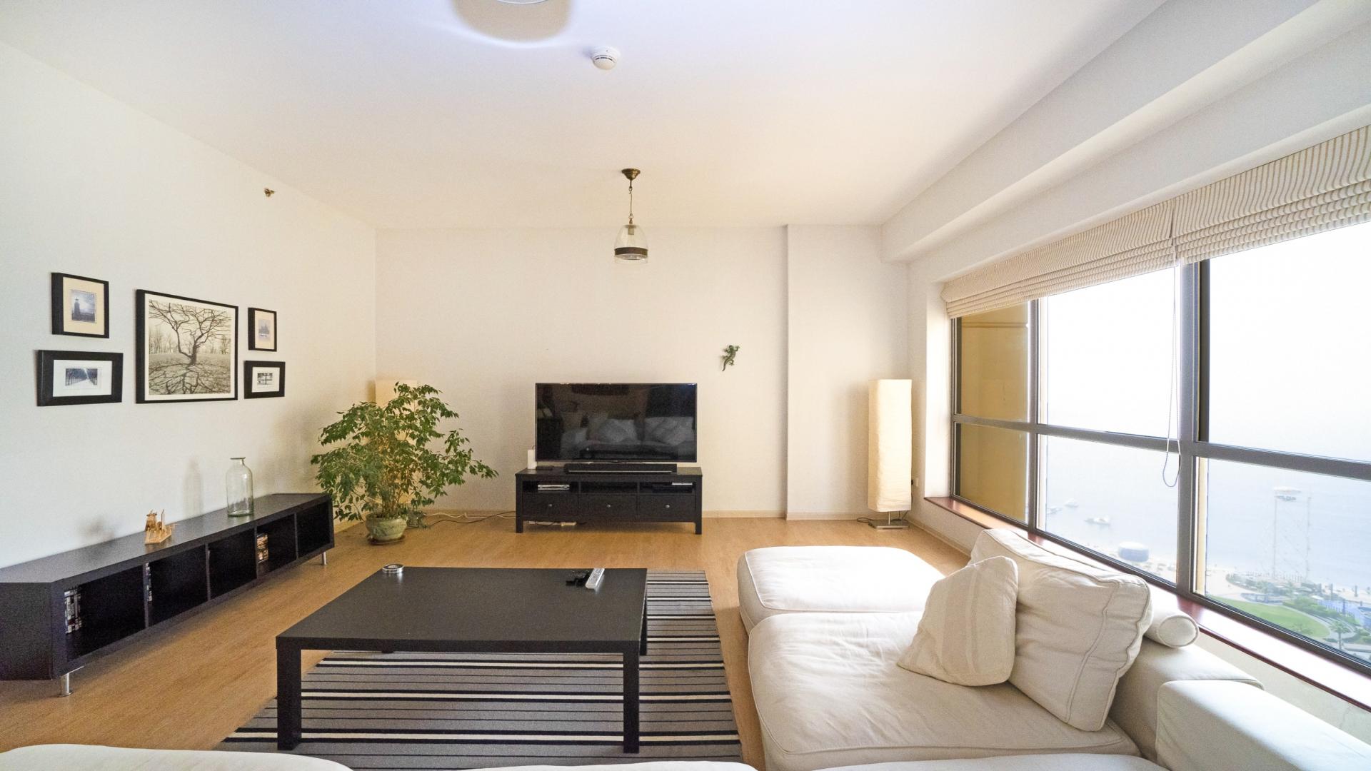 Spacious living room in 3-bedroom JBR apartment, modern decor, bright and airy space