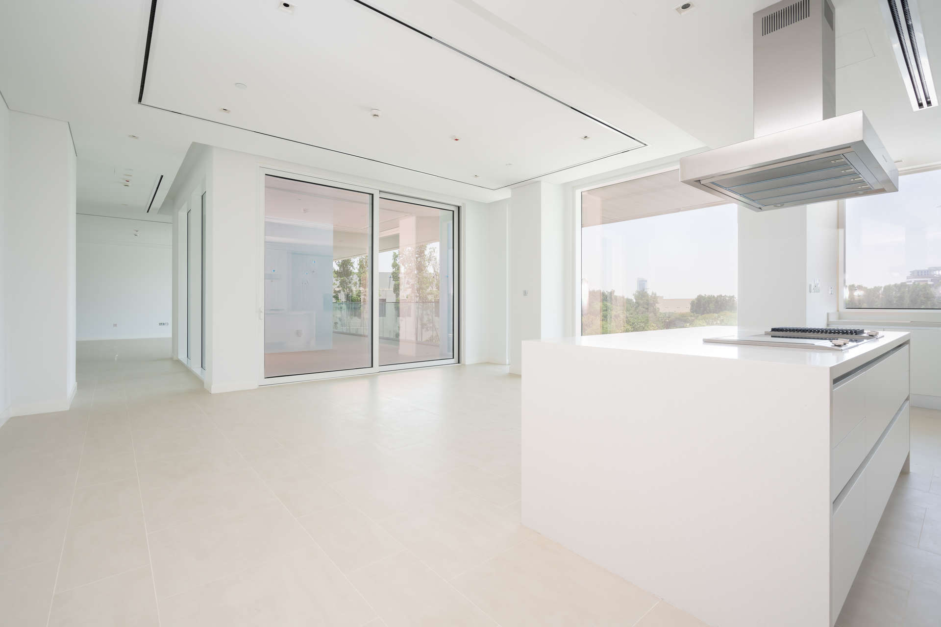Spacious living room with large windows in Al Barari's Seventh Heaven apartment