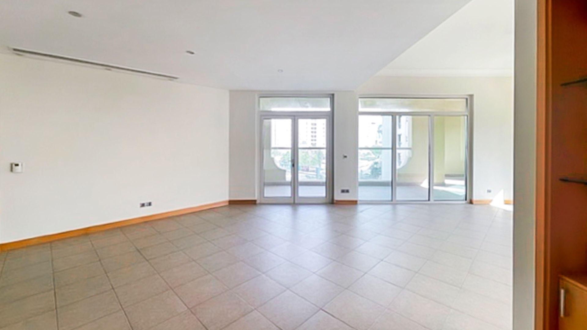 Modern kitchen in Shoreline beachfront apartment, Palm Jumeirah, with granite countertops and wood cabinets