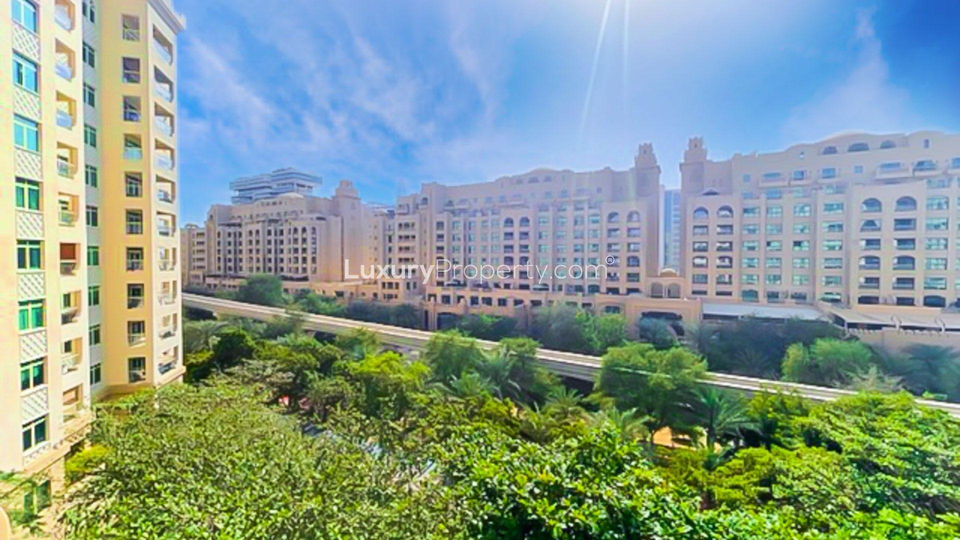 Spacious living area in beachfront Shoreline Apartment, Palm Jumeirah, with large windows and tile flooring