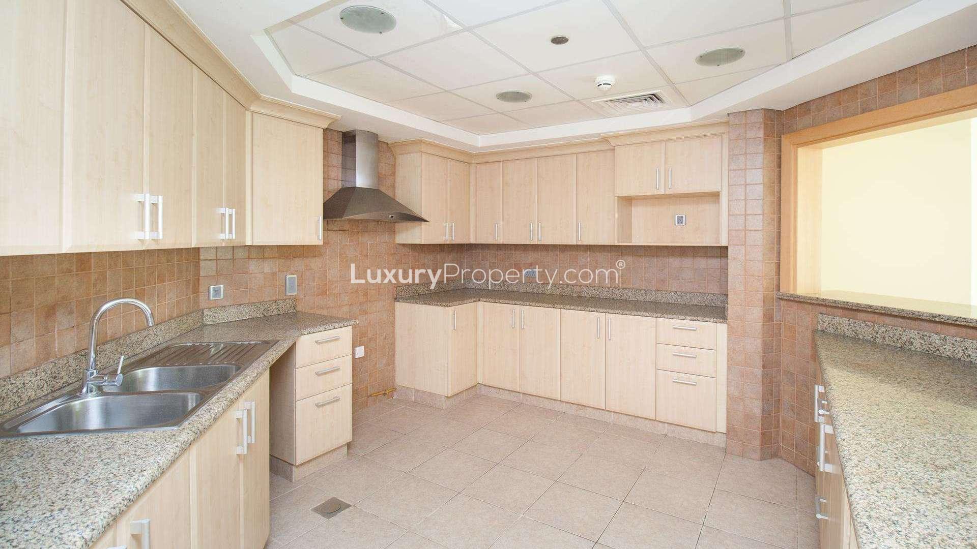 Beachfront apartment view, Shoreline Apartments, Palm Jumeirah, lush greenery, sunny day