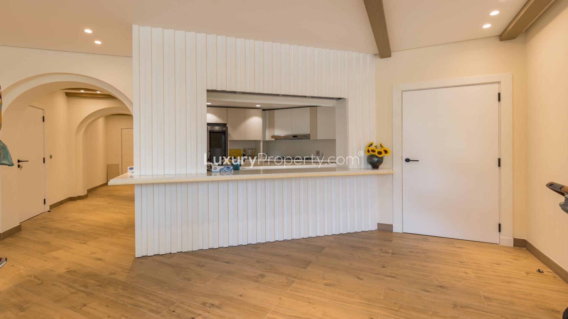 Living room in upgraded Palm Jumeirah apartment with modern decor and garden views