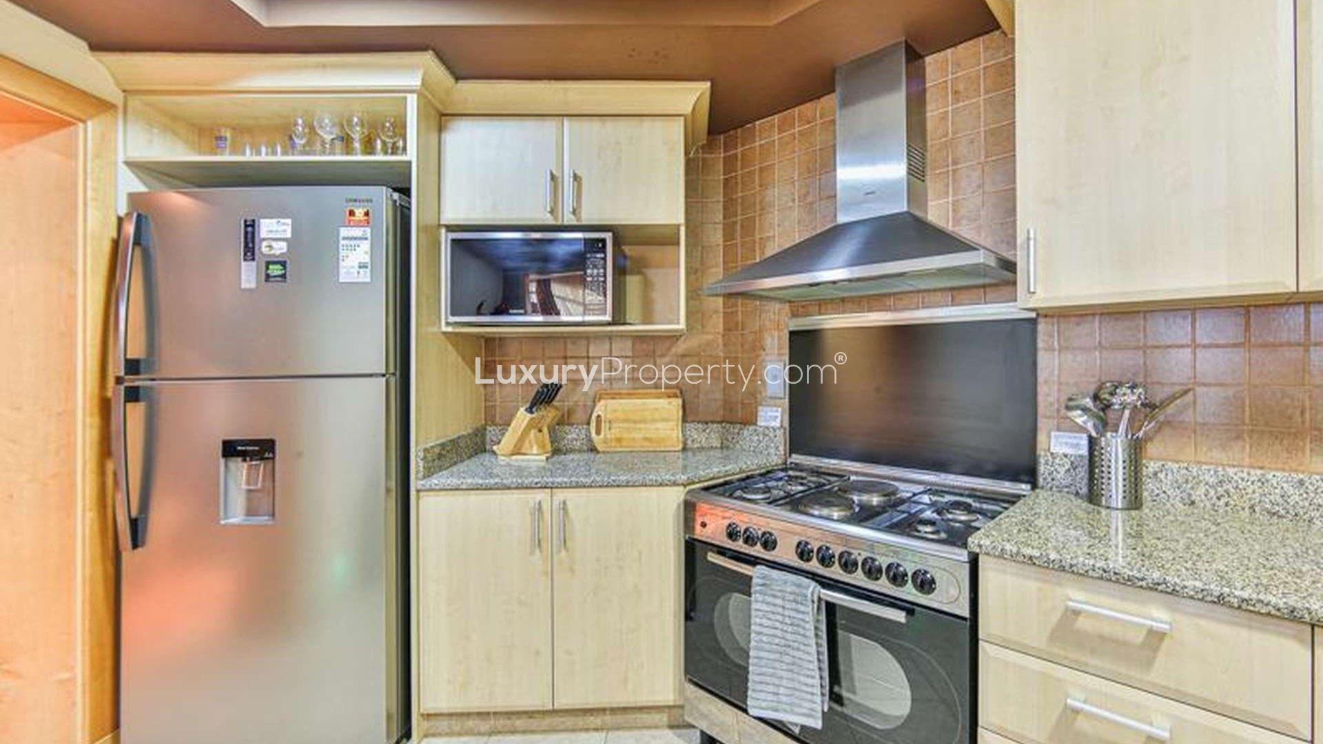 Mid-floor Shoreline Apartments bedroom with red accent wall, Palm Jumeirah, for sale