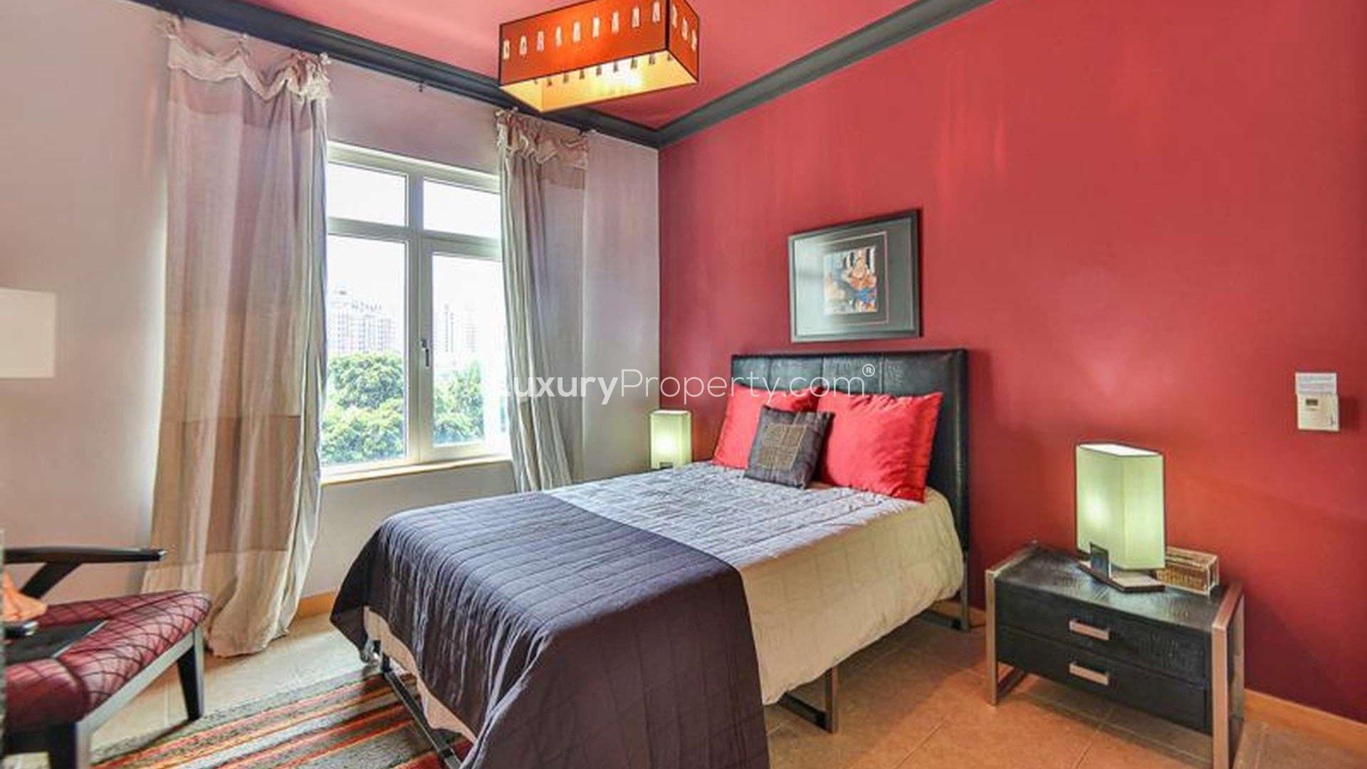 Elegant bedroom in Shoreline Apartments, Palm Jumeirah, featuring classic furniture and chandelier