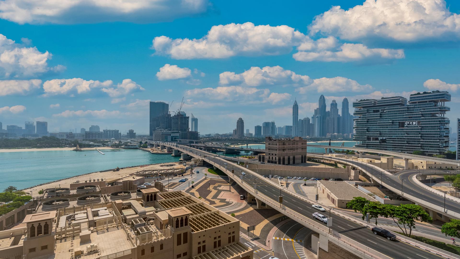 High floor apartment view of Palm Jumeirah shoreline and city skyline, Dubai