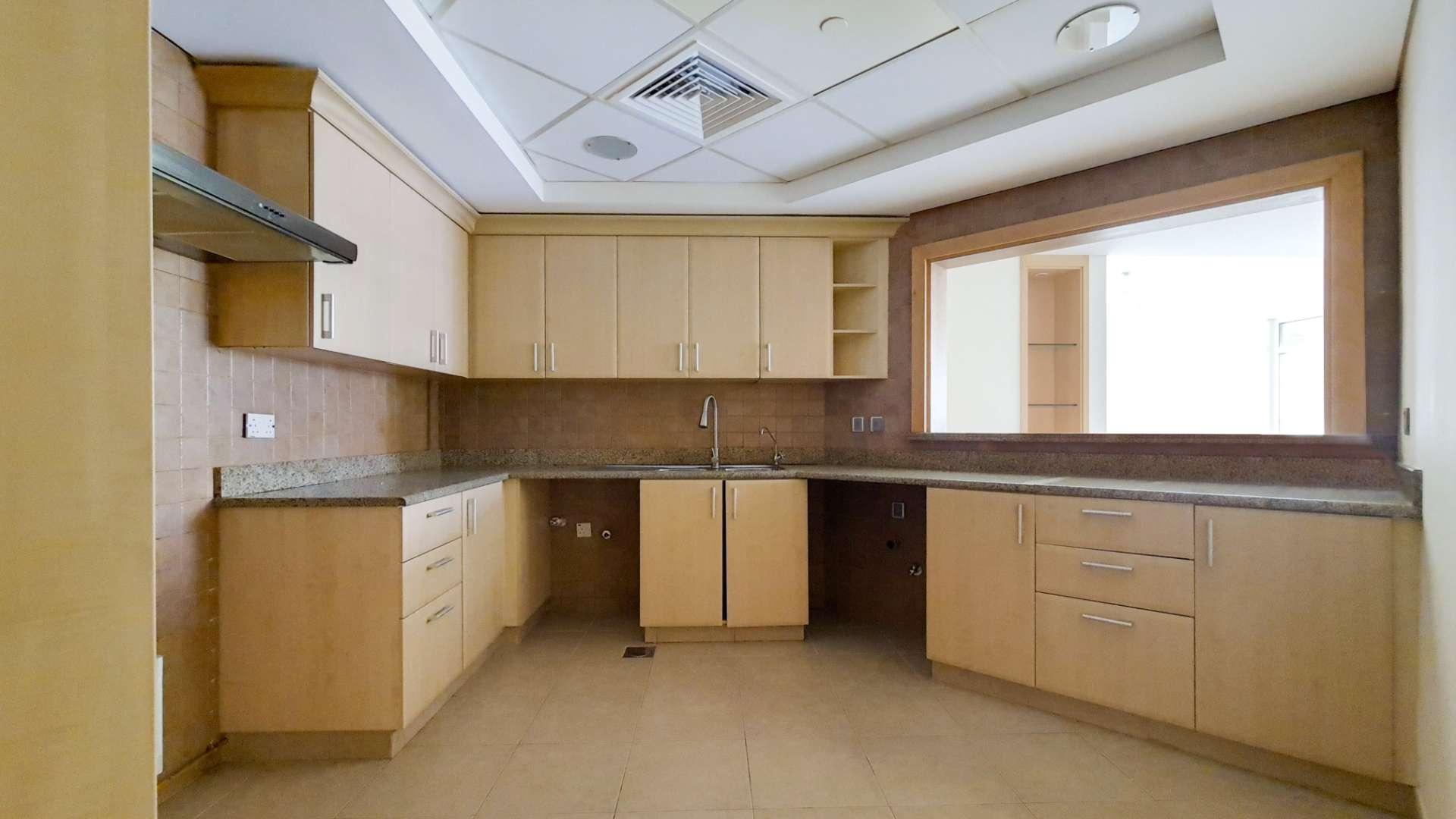 Empty living room with large windows in Shoreline Apartments, Palm Jumeirah, for sale