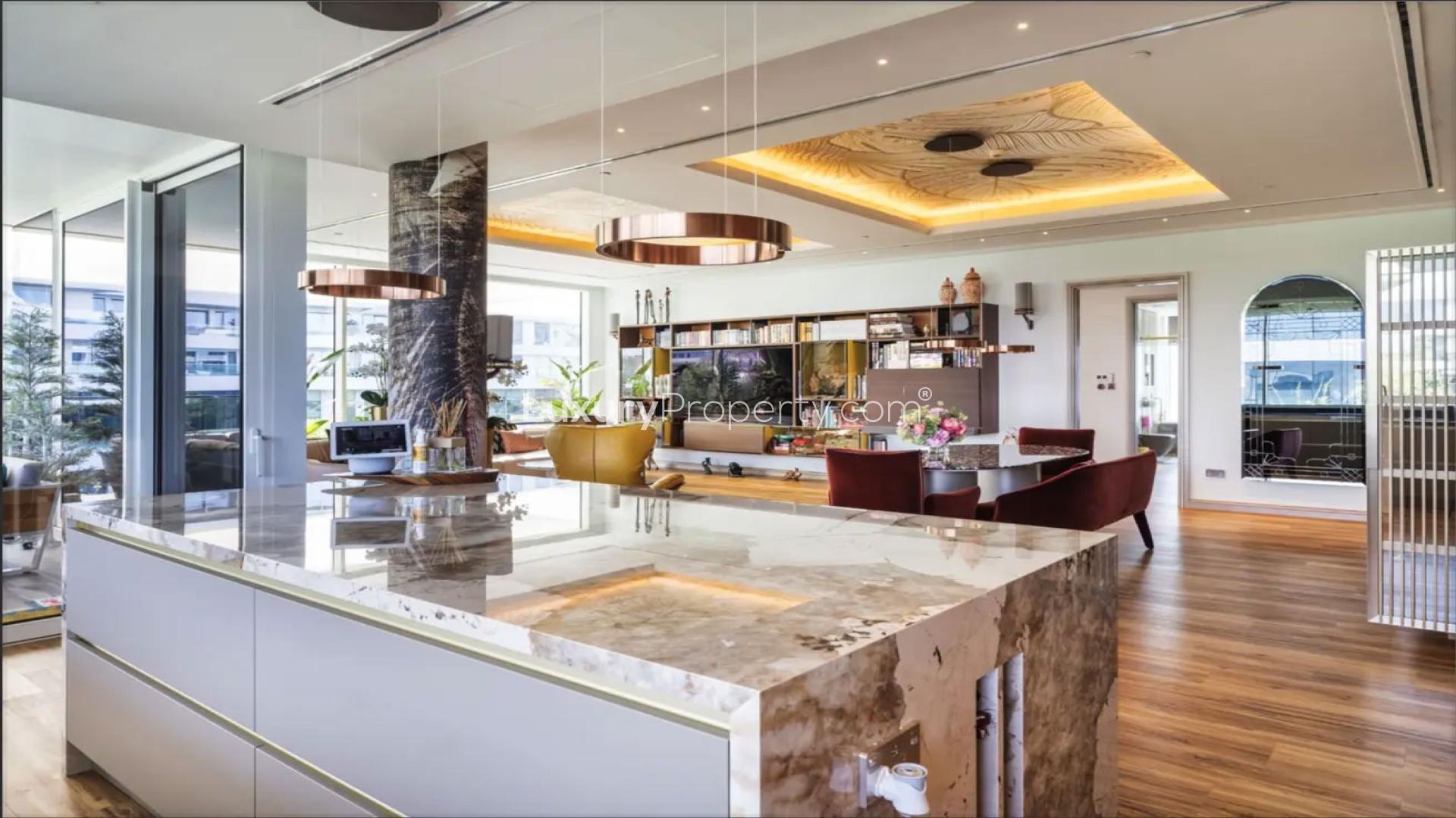 Modern living area in Al Barari apartment with elegant decor and large windows