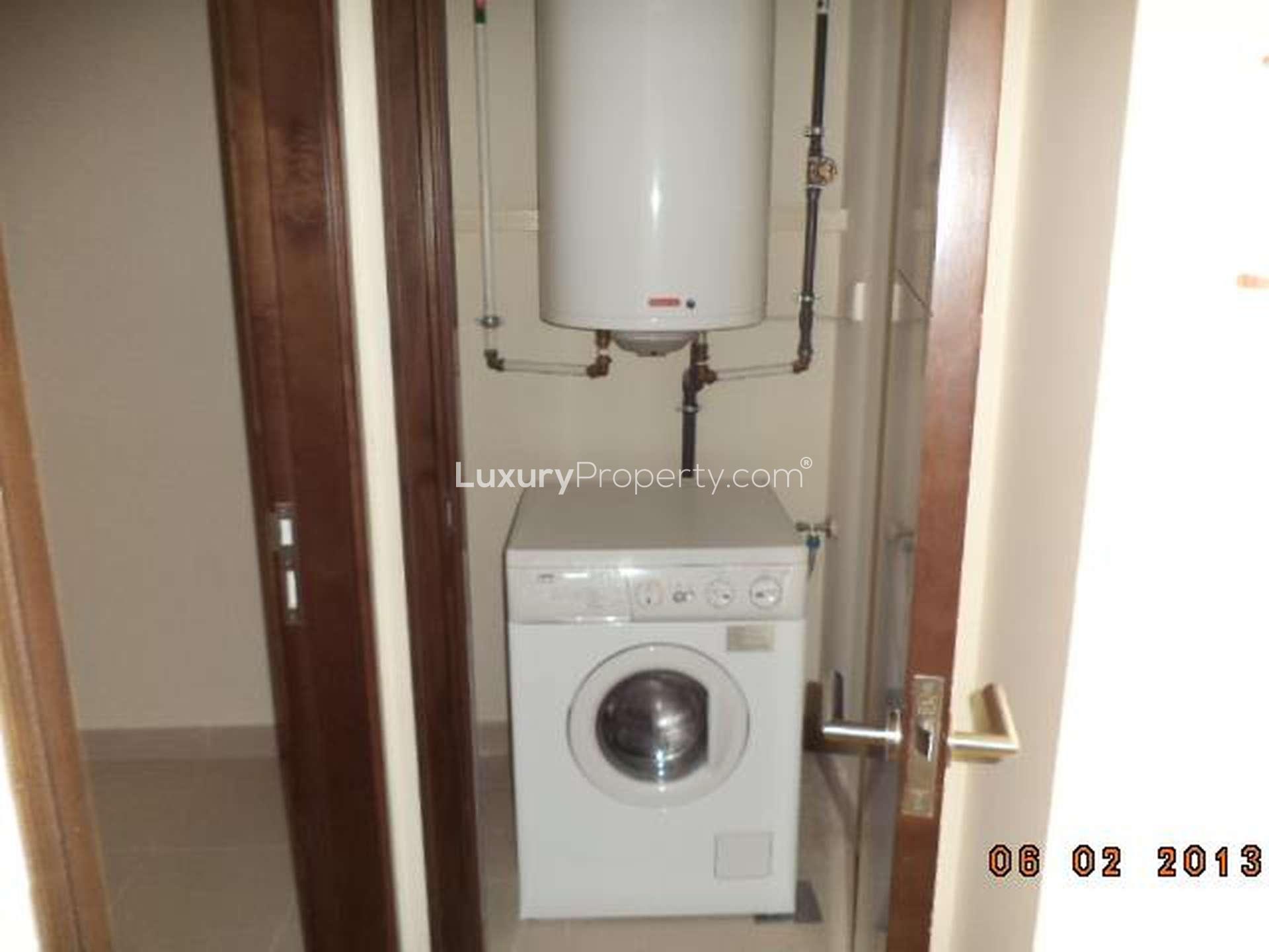 Compact kitchen in 3-bedroom apartment, South Ridge, Downtown Dubai, featuring modern cabinetry