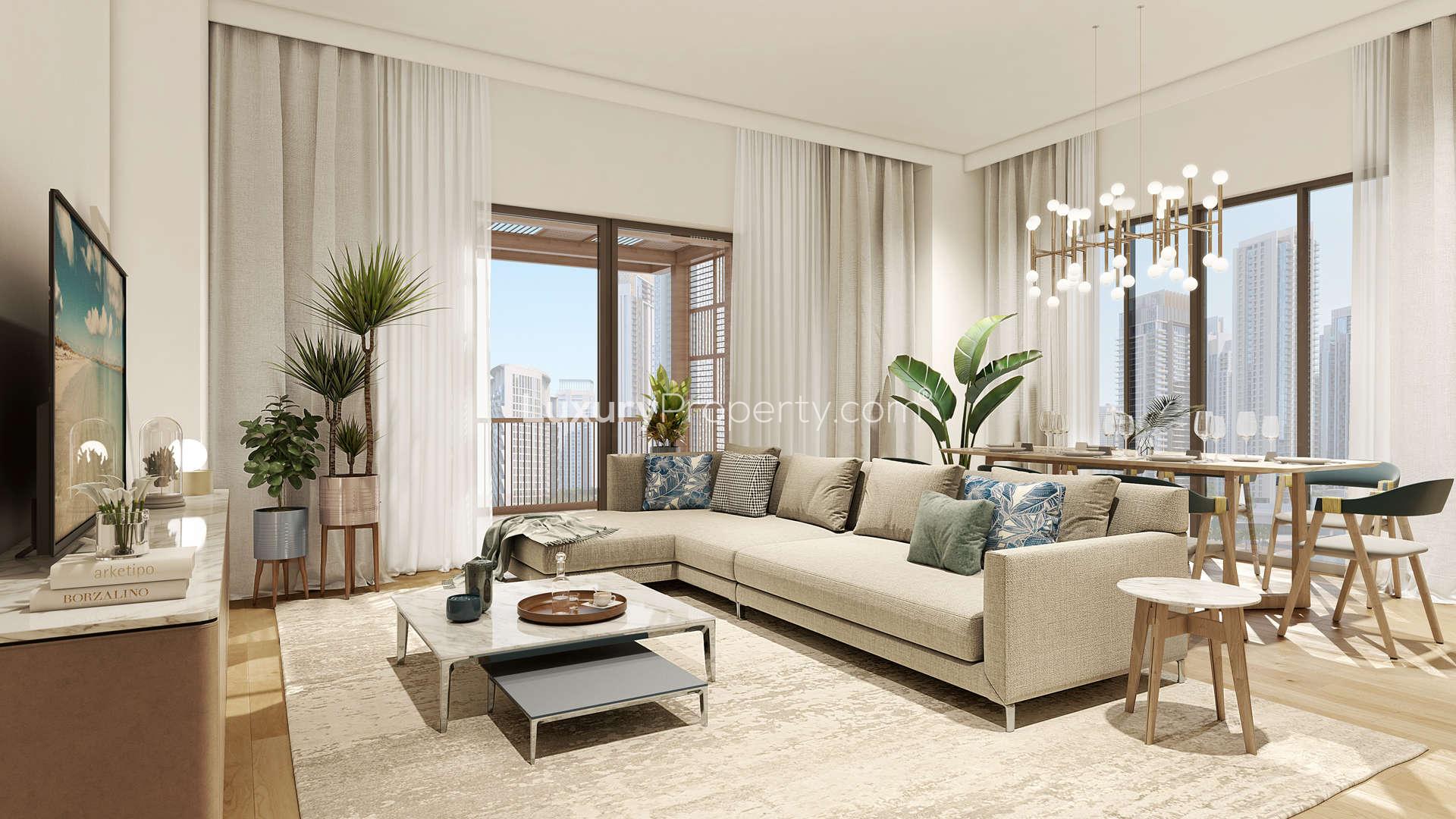 Modern kitchen in three-bedroom apartment, Dubai Creek Harbour, featuring sleek appliances and stylish décor