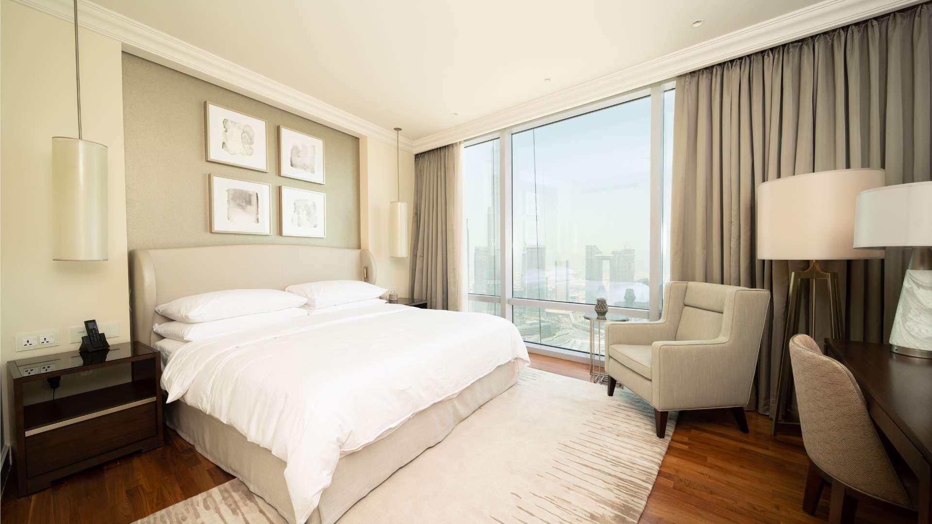 Luxurious bedroom in serviced apartment, Downtown Dubai, with Burj Khalifa view through large window