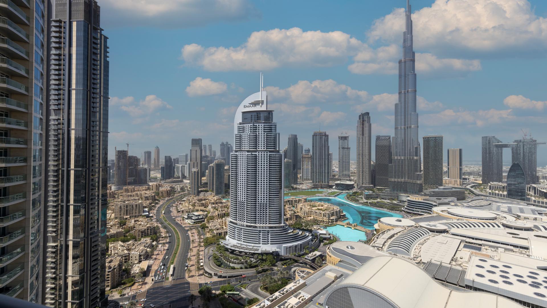 "Spacious furnished living room with Burj Khalifa view, Downtown Dubai apartment for sale.",Luxury apartment view of Burj Khalifa and Downtown Dubai skyline, The Address Residence Fountain Views