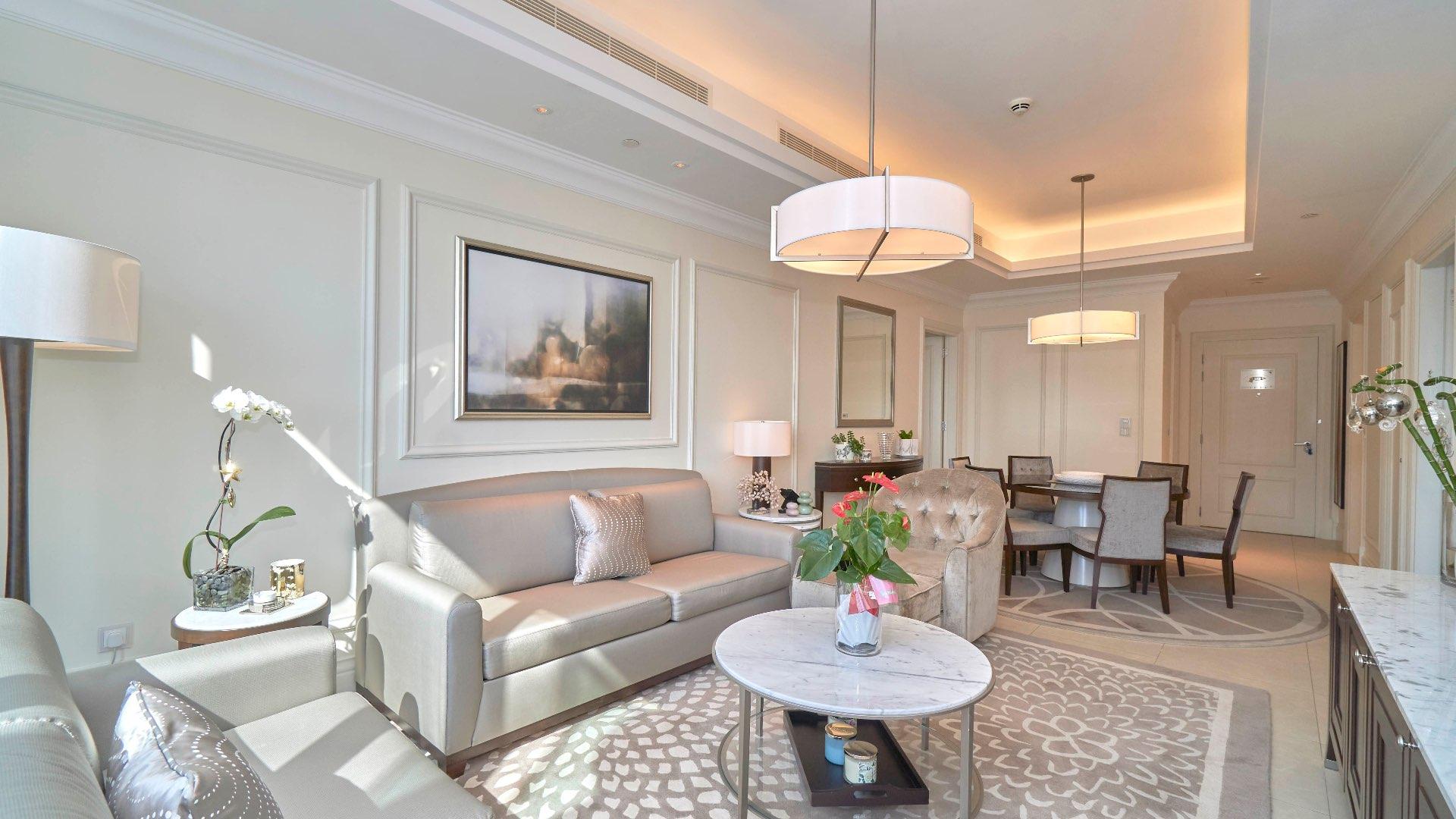 "Stunning Downtown Dubai skyline view from exclusive apartment, featuring iconic Burj Khalifa.",Luxurious living room in Downtown Dubai apartment, modern decor, natural light, elegant furnishings