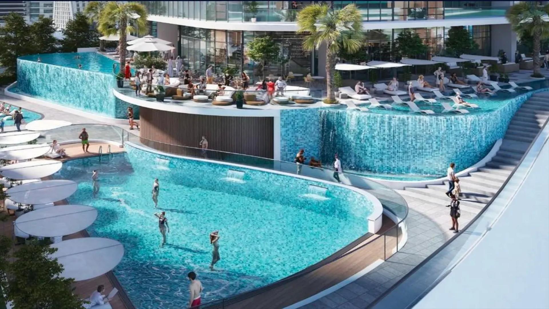 Luxurious poolside view at Sobha Seahaven apartment, Dubai Harbour, overlooking the sea