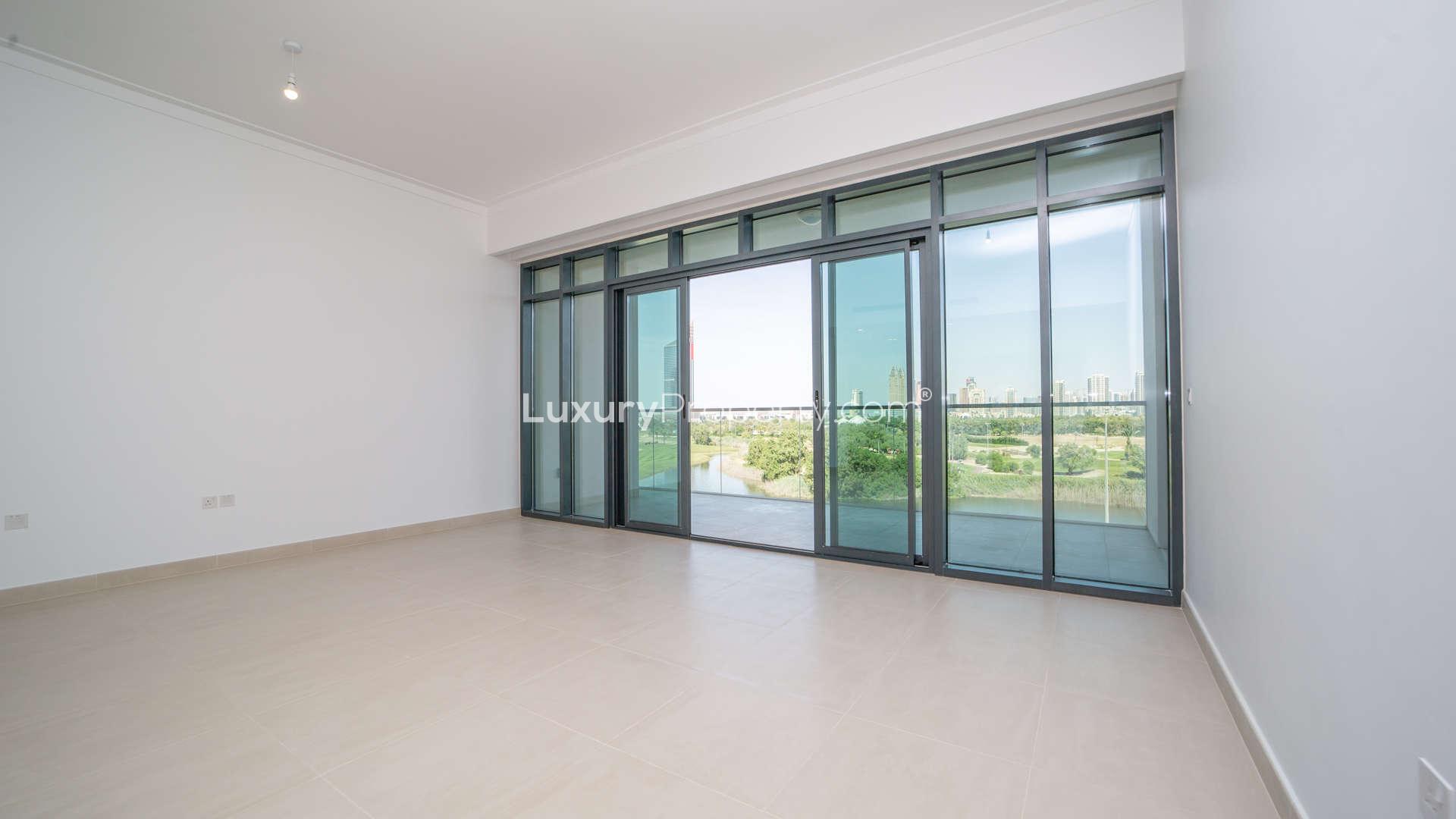 Empty room with large windows overlooking Emirates Golf Course, The Hills A, Dubai apartment