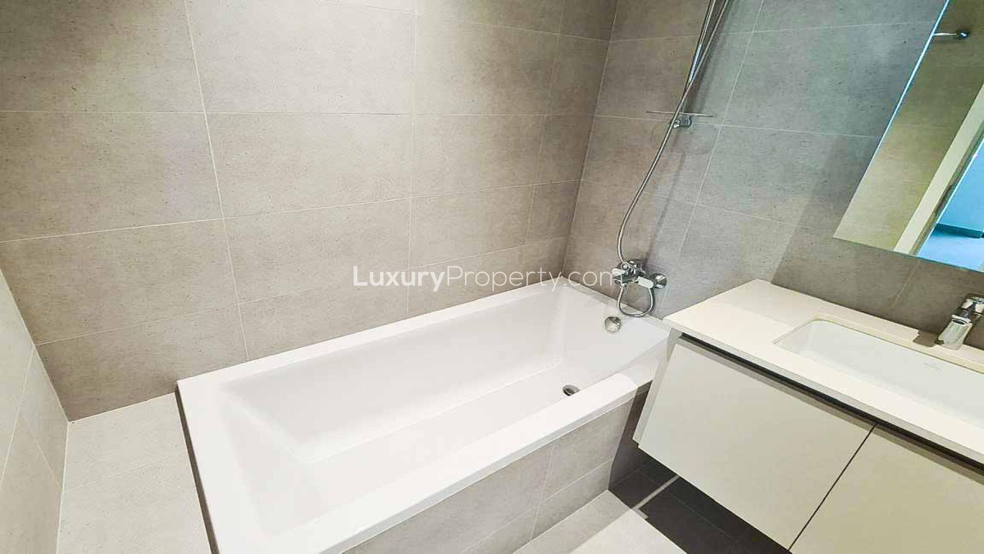 Modern kitchen and living area in Breeze at Dubai Creek Harbour apartment for sale