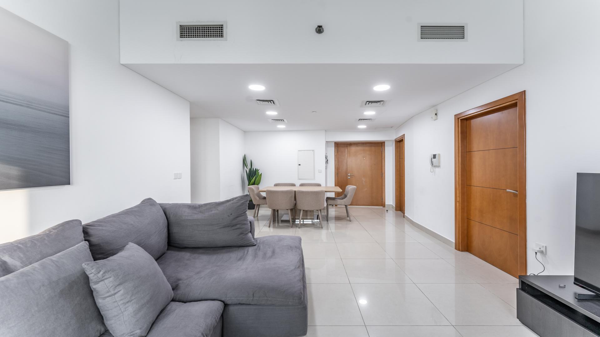 Modern living room and dining area in 3-bed apartment, Ocean Heights, Dubai Marina