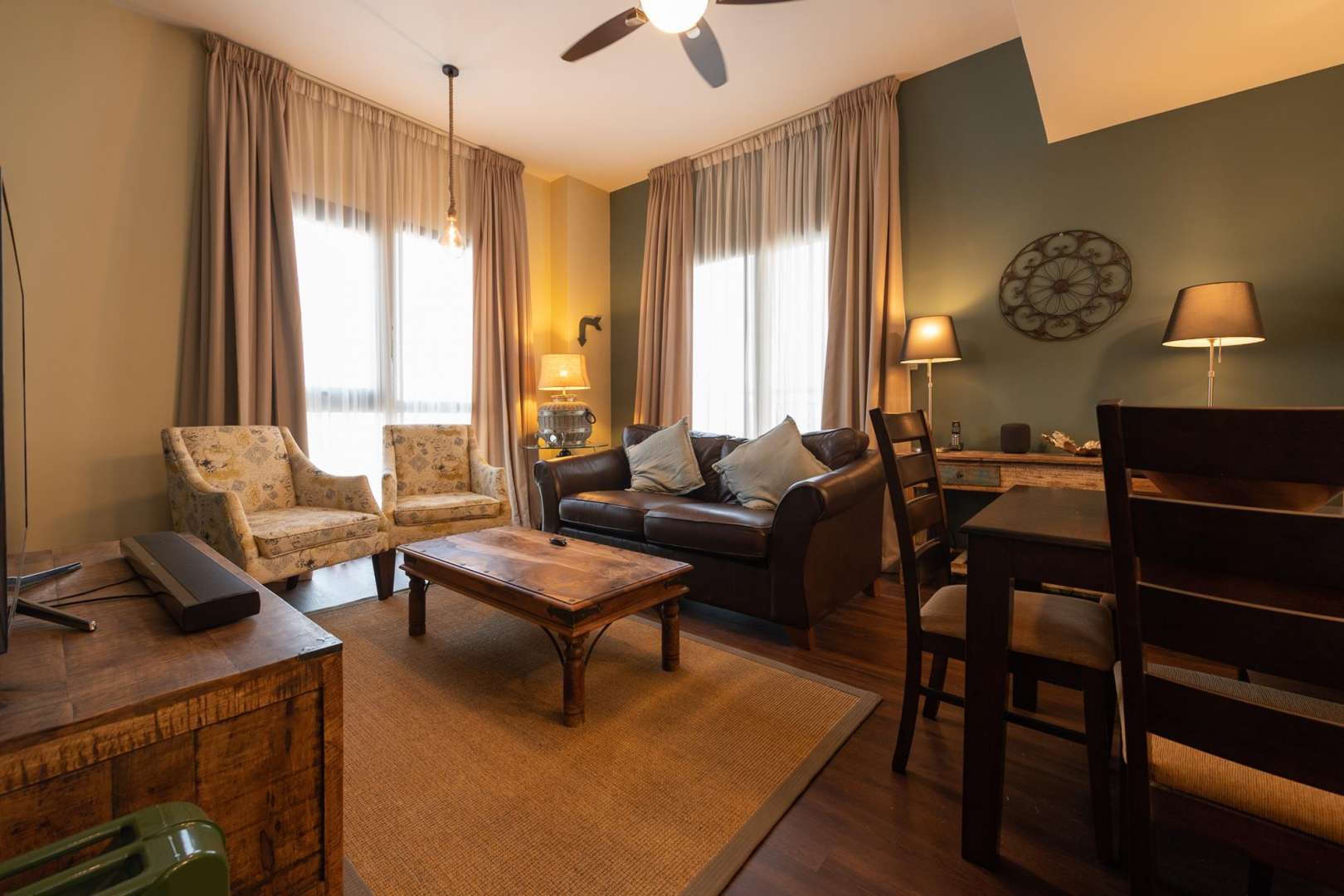 Balcony view of Zahra Apartments, Town Square, overlooking modern buildings and palm-lined street
