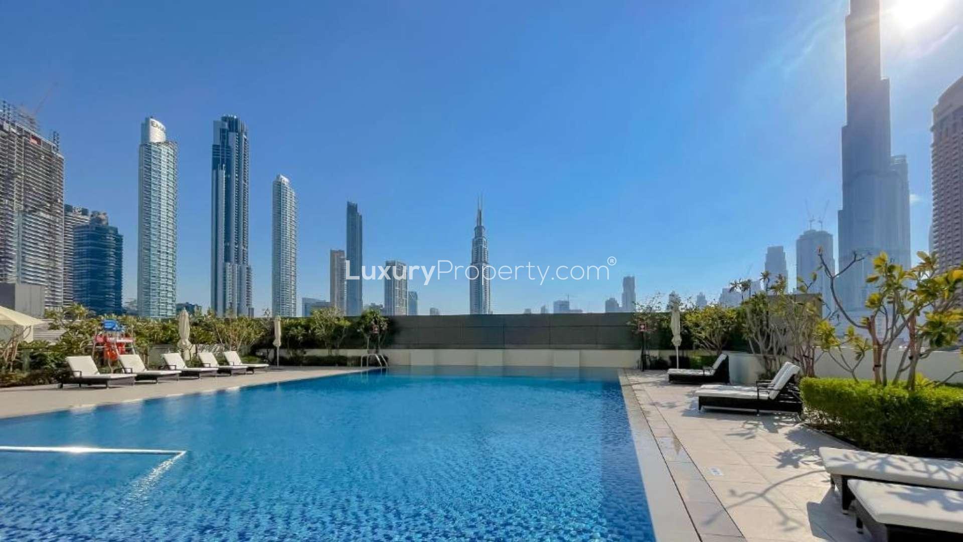 "High-floor apartment balcony with Burj Khalifa view in Downtown Dubai, Downtown Views II.",High floor apartment pool with Burj Khalifa views in Downtown Views II, Dubai