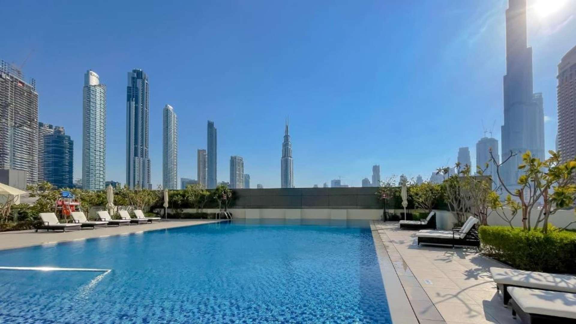 "High-floor apartment balcony with Burj Khalifa view in Downtown Dubai, Downtown Views II.",High floor apartment pool with Burj Khalifa views in Downtown Views II, Dubai