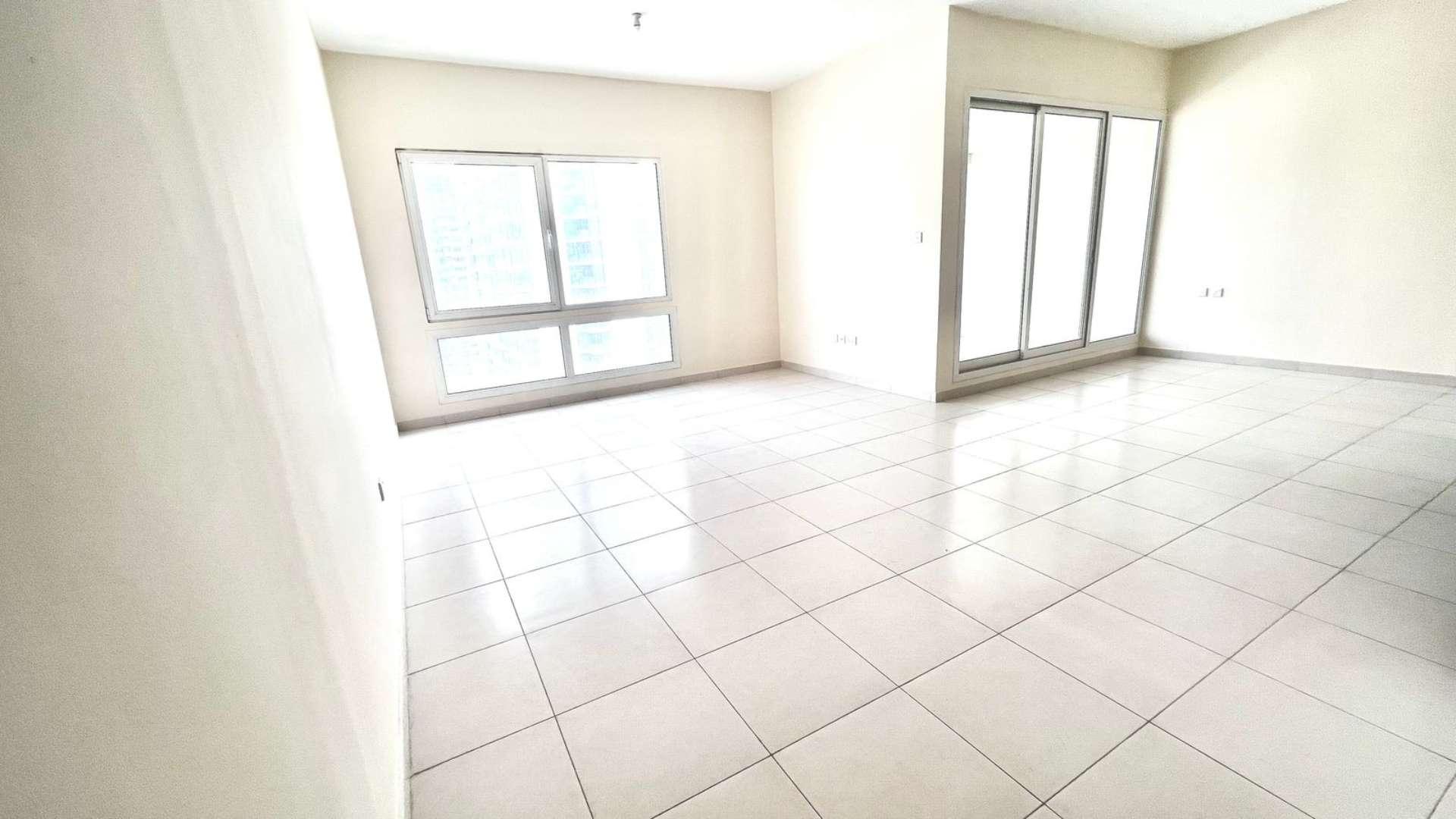 Bright, spacious living area in Marina View Penthouse, Dubai Marina, with large windows