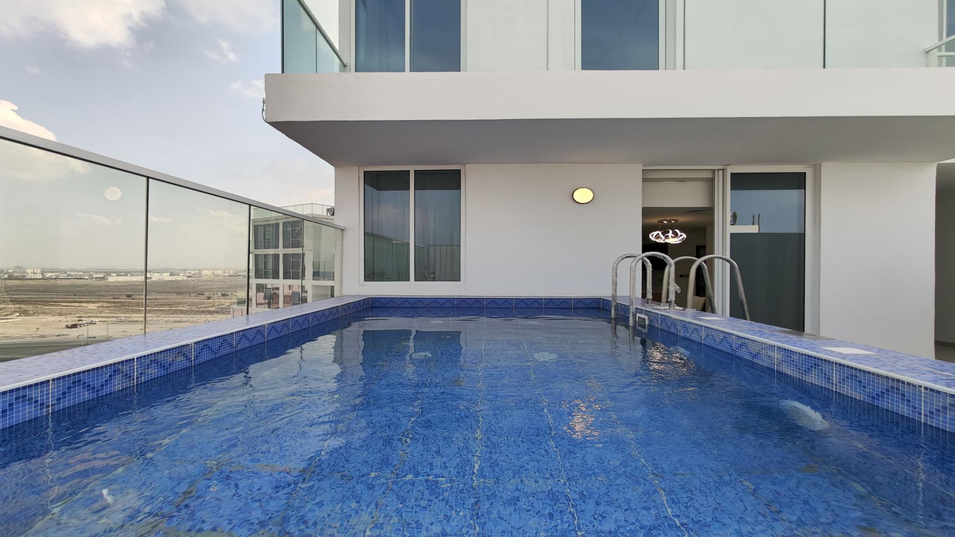 Luxurious Al Furjan penthouse living room with modern decor and stunning city views