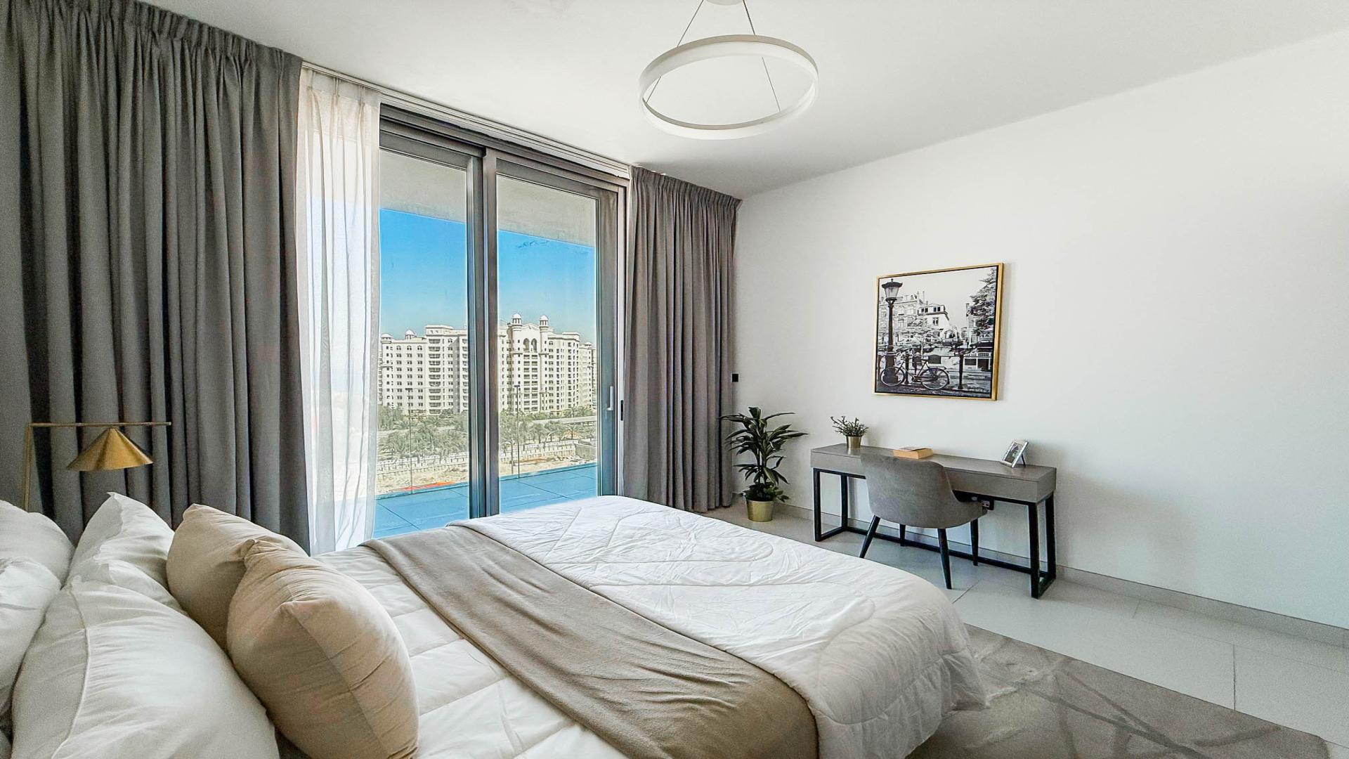 Modern open-plan kitchen and living area in Soho Palm Jumeirah penthouse for rent