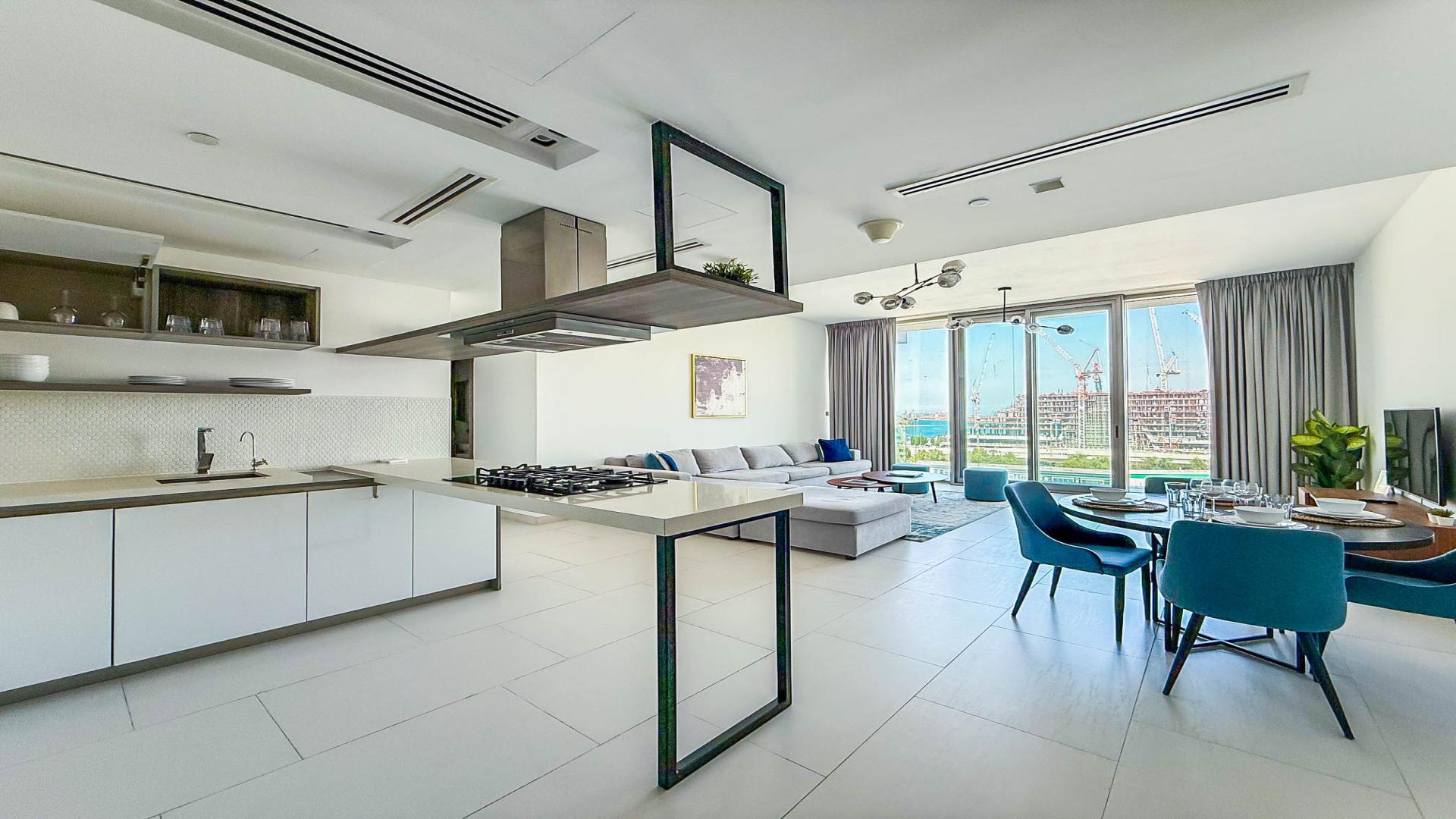 Modern living room in Soho Palm Jumeirah penthouse with open kitchen and stylish decor