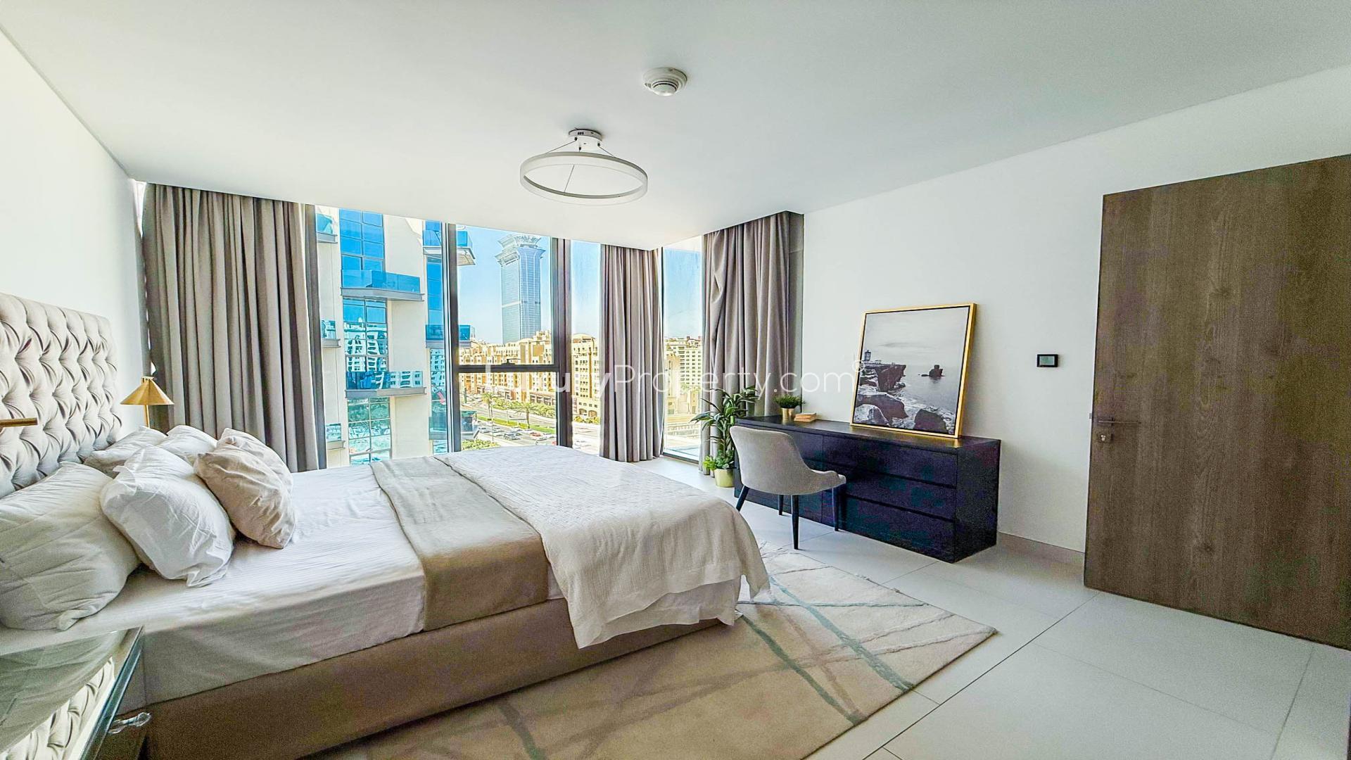 Modern bedroom with balcony view in Soho Palm Jumeirah penthouse for rent