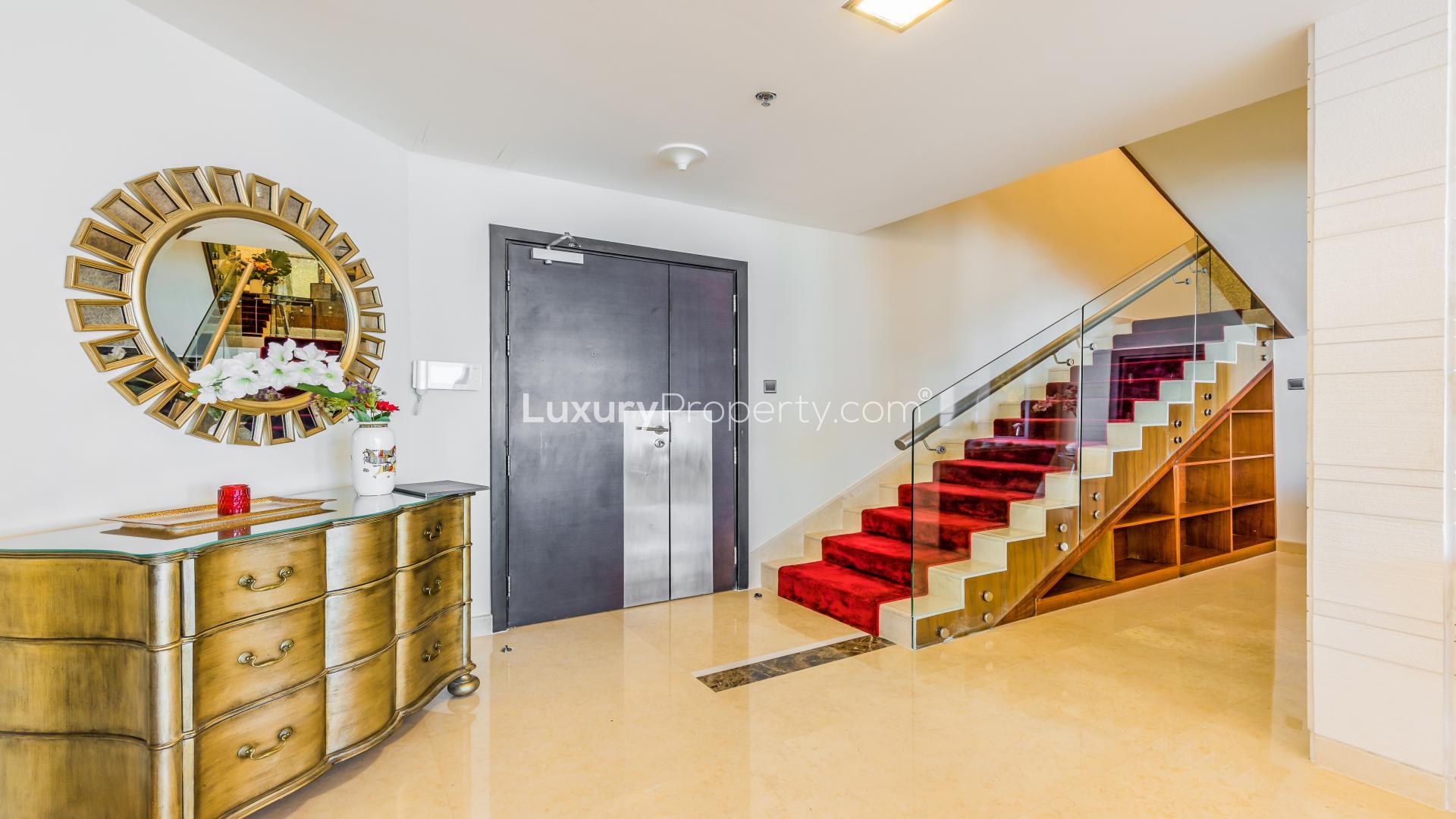Luxury living room in Dubai Marina penthouse, featuring elegant decor and grand piano