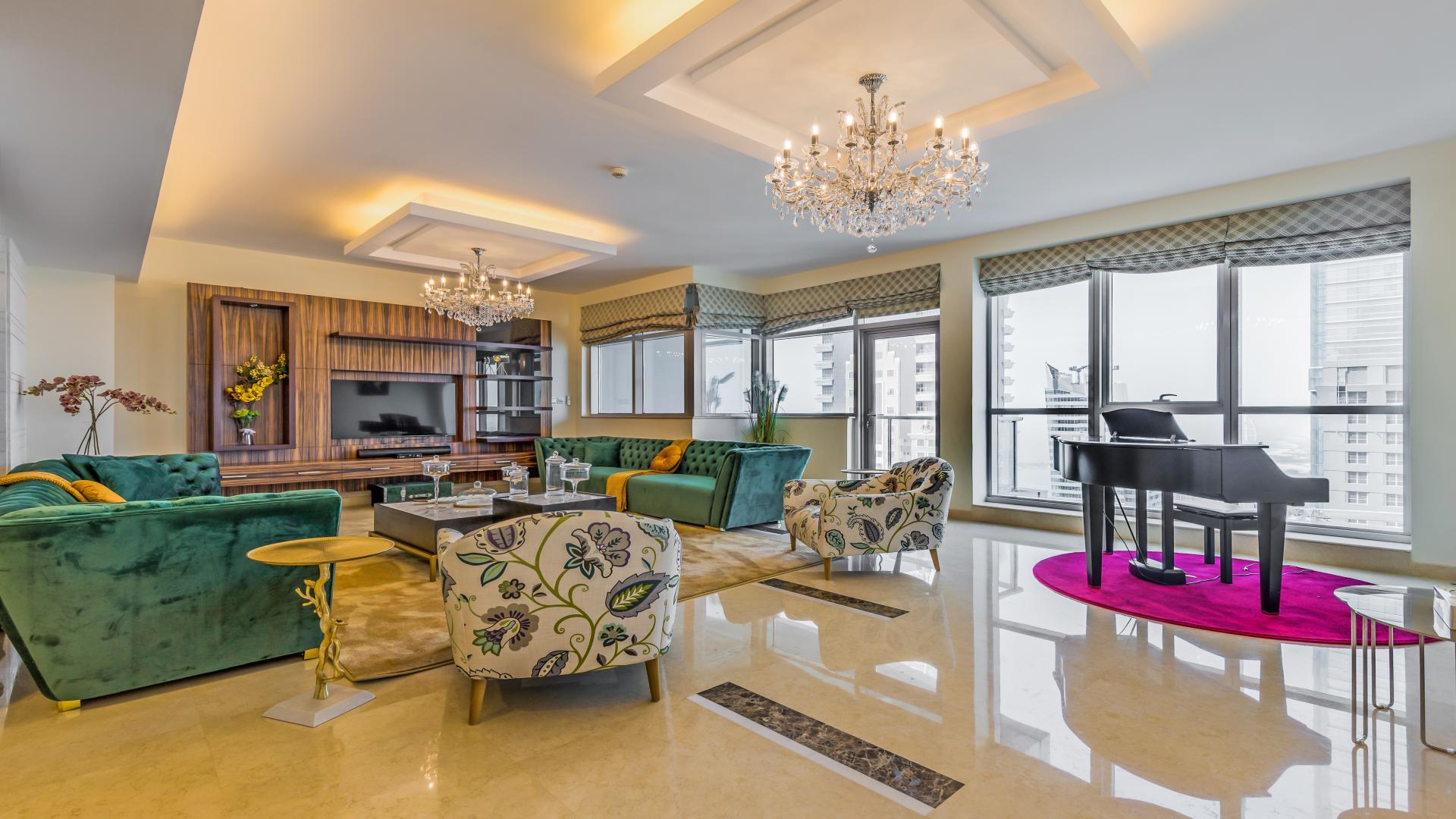 Luxurious living room in Torch Tower penthouse, Dubai Marina, with elegant decor and chandeliers