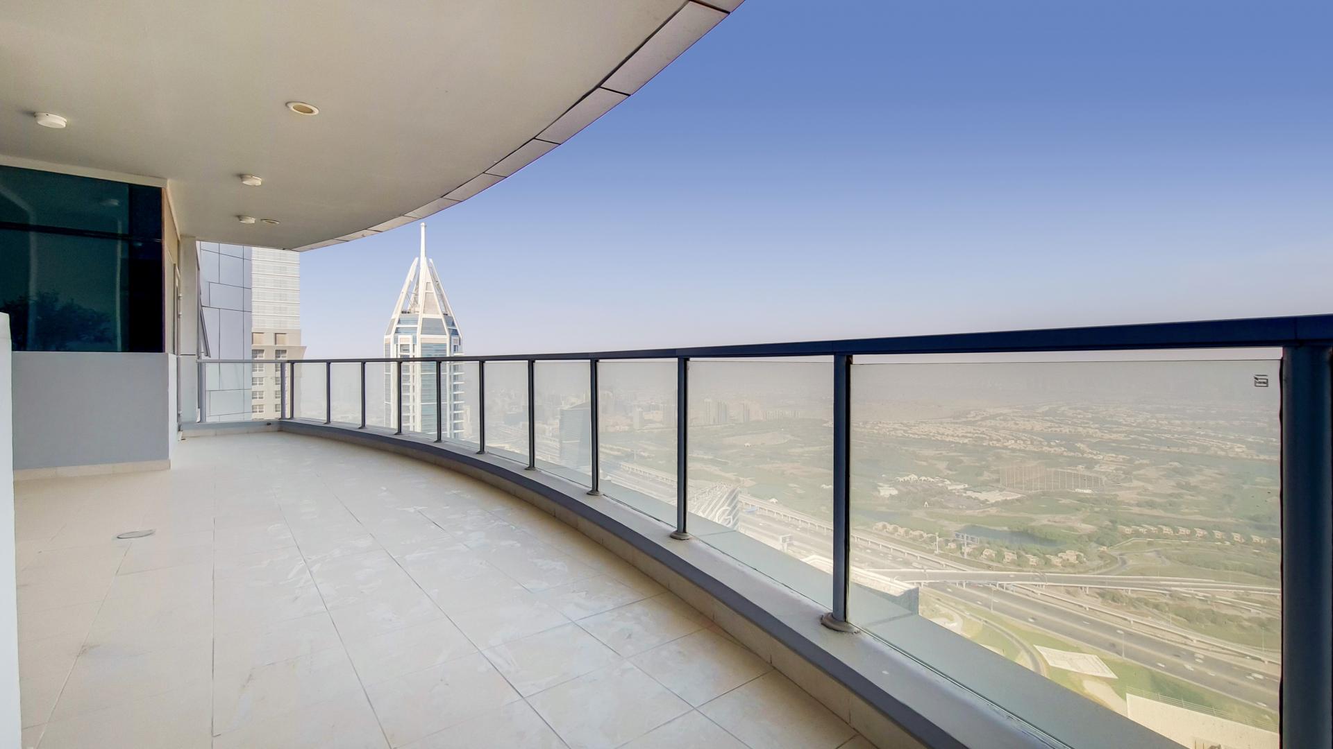 High-floor penthouse balcony with stunning Dubai Marina views at The Torch, available for rent