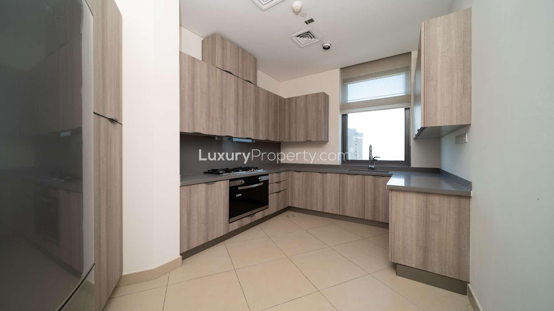 Modern kitchen and dining area in Business Bay penthouse with balcony view