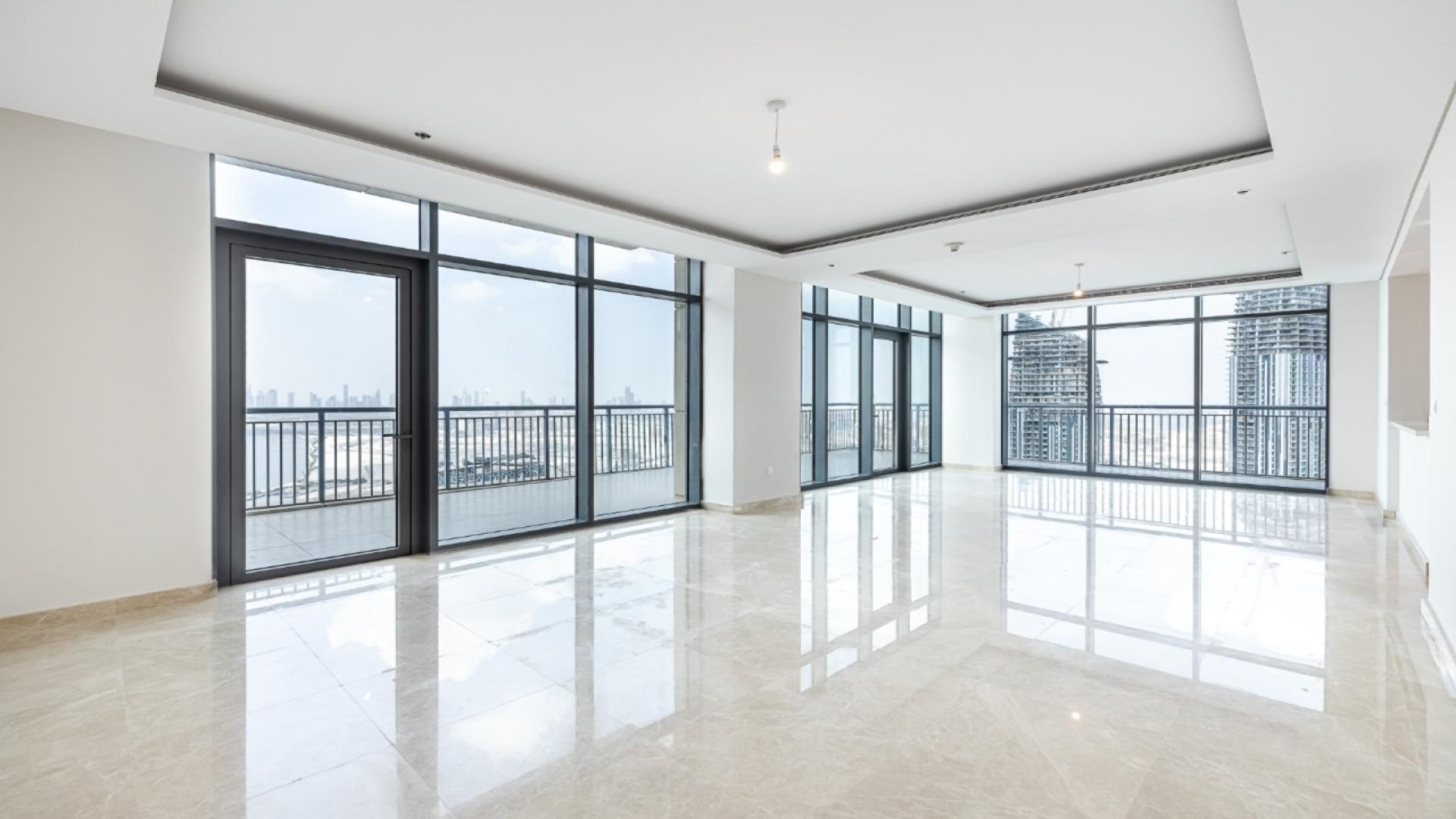 Luxurious penthouse living room with floor-to-ceiling windows, Dubai Creek Harbour views