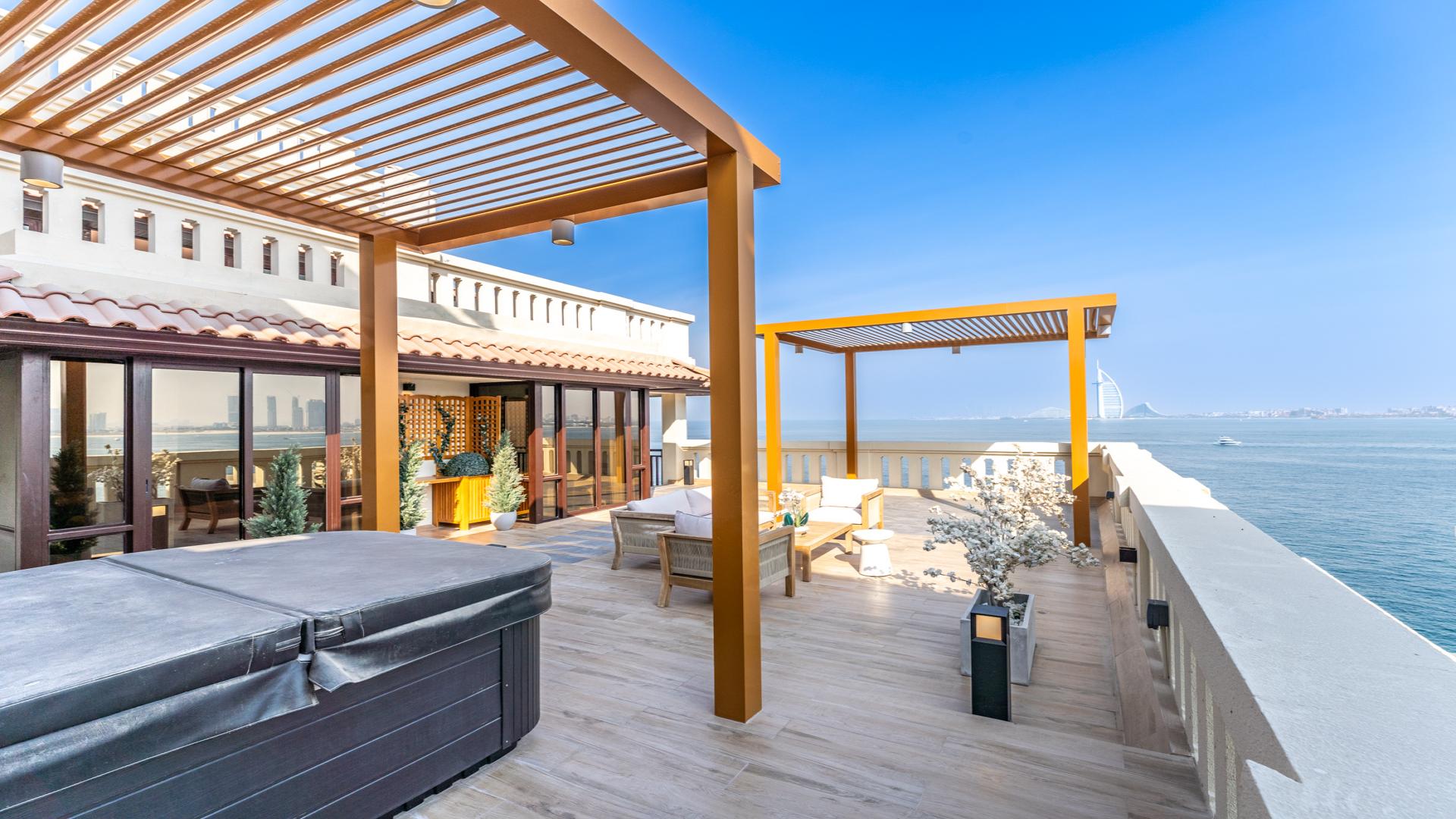 Luxurious penthouse living room with ocean view terrace at Palm Jumeirah, Dubai