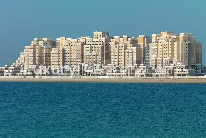 Modern kitchen in 3-bedroom penthouse, Palm Jumeirah, featuring sleek cabinets and mosaic backsplash