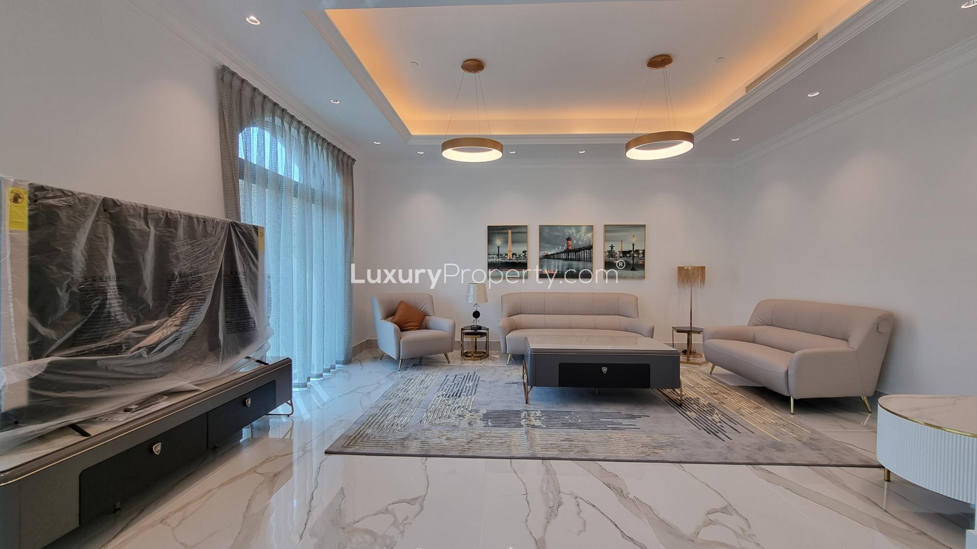 "Park-facing penthouse view in Golden Mile, Palm Jumeirah, showcasing lush greenery and architecture.",Modern living room in Golden Mile penthouse, Palm Jumeirah, with elegant furniture and decor