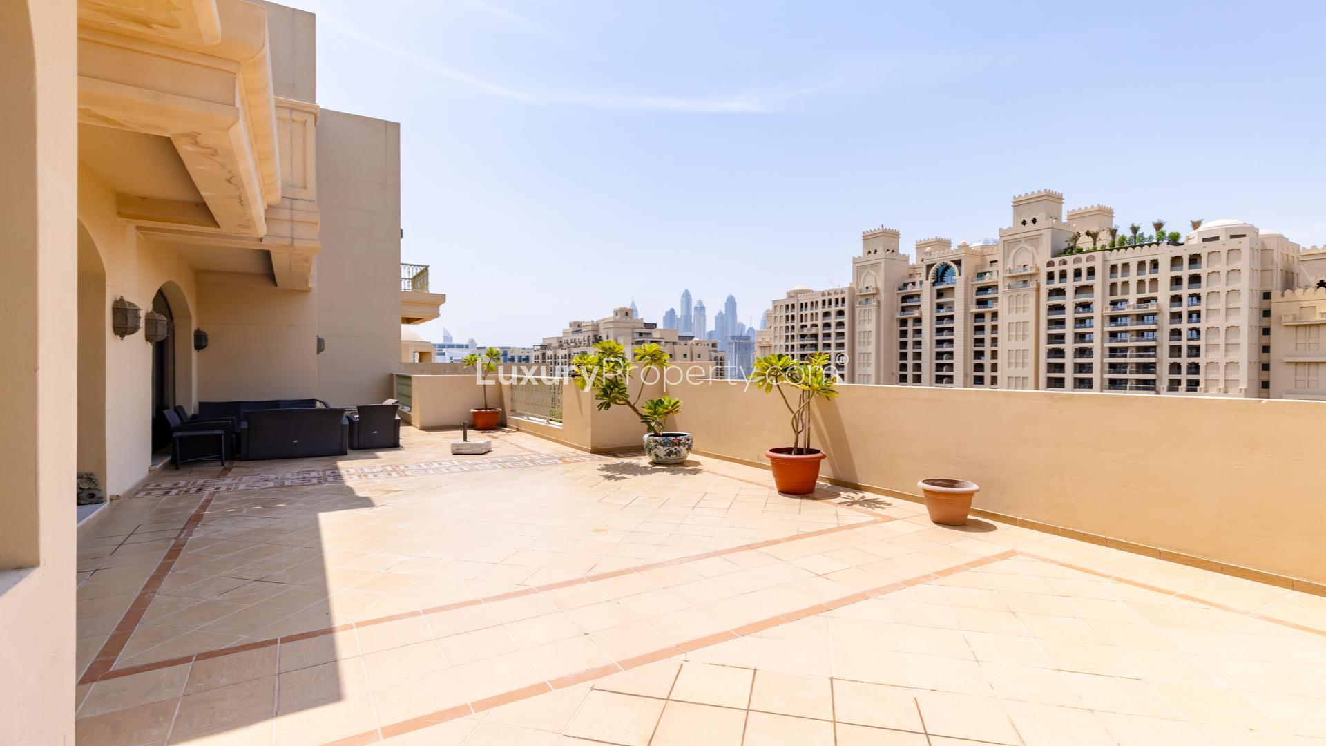 "Scenic view from duplex penthouse terrace overlooking Palm Jumeirah near Nakheel Mall, Golden Mile.","Spacious terrace of Palm Jumeirah penthouse near Nakheel Mall, overlooking city skyline.",Luxurious living room in Palm Jumeirah penthouse near Nakheel Mall, Golden Mile community