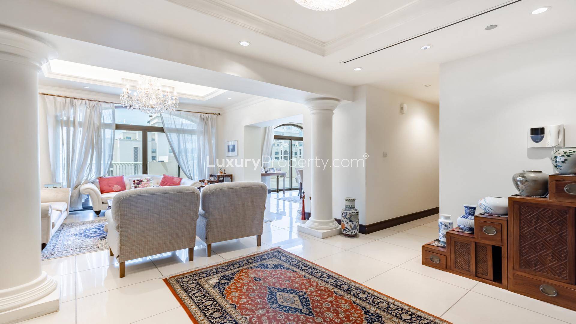 Elegant living room in Palm Jumeirah penthouse for sale, featuring luxurious decor and balcony view