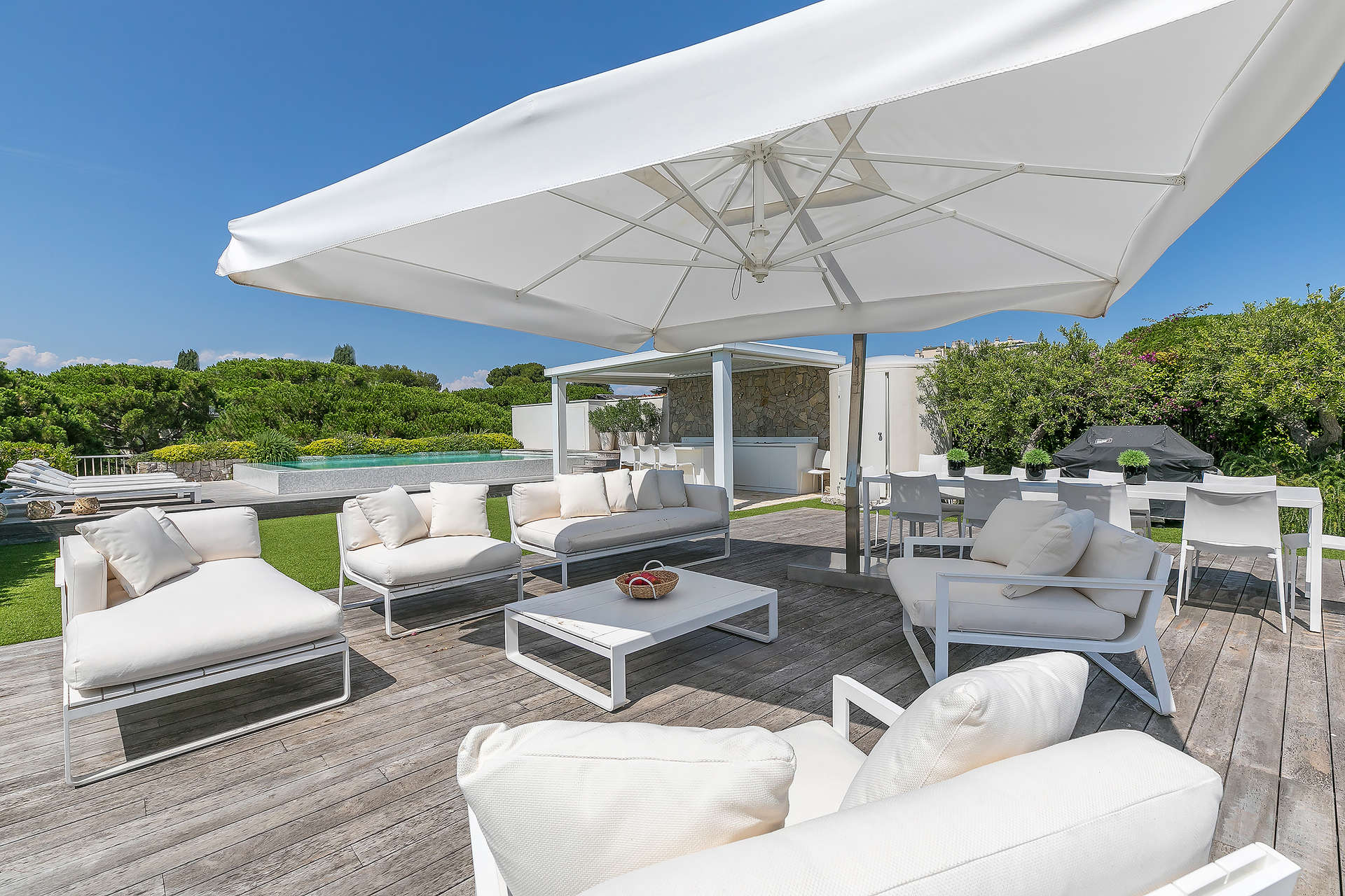 Luxury Cap d'Antibes penthouse terrace with sea view, outdoor dining furniture, and potted plants