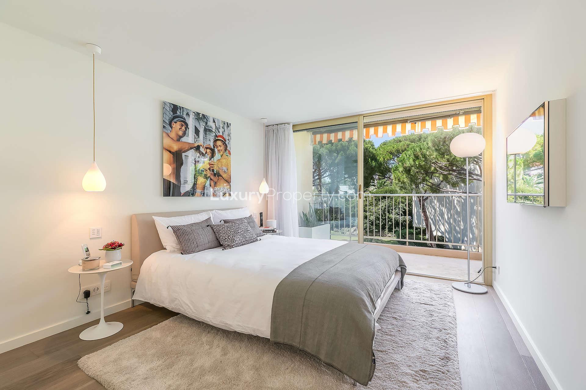 Outdoor terrace with seating and umbrella at luxury penthouse, Cap d'Antibes, French Riviera