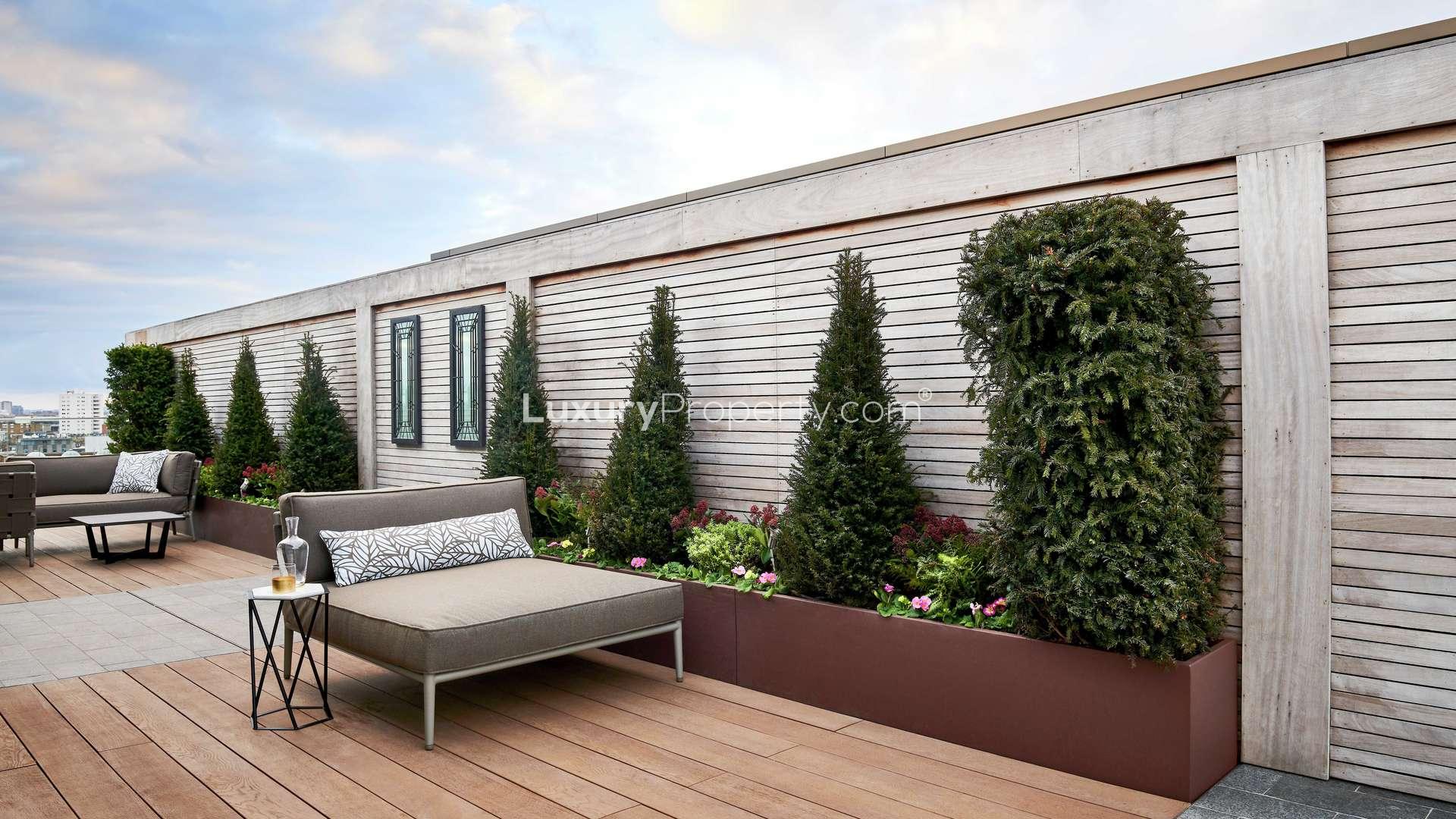 Luxurious marble bathroom in Chelsea Creek penthouse with double sink and freestanding bathtub